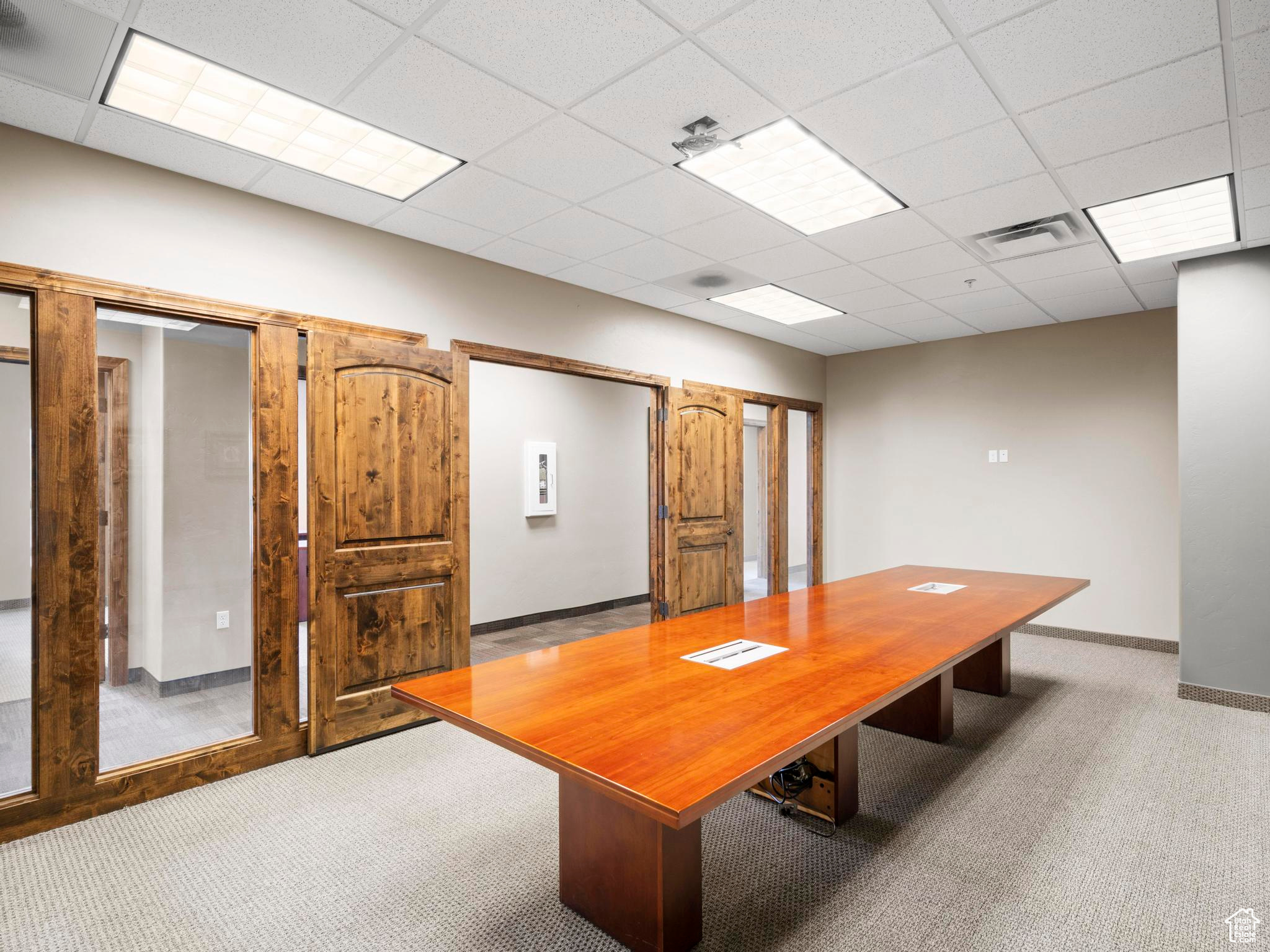 Interior space featuring carpet flooring and a paneled ceiling