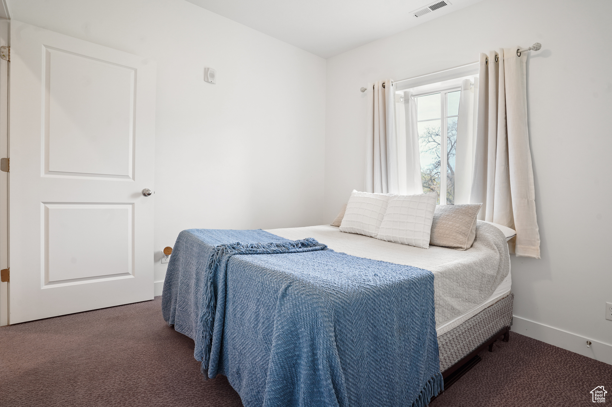 Bedroom featuring dark carpet