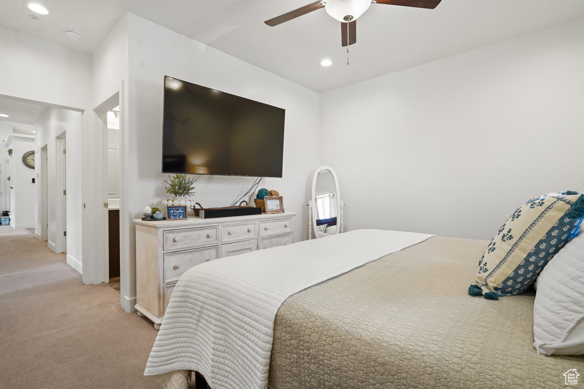 Carpeted bedroom featuring ceiling fan