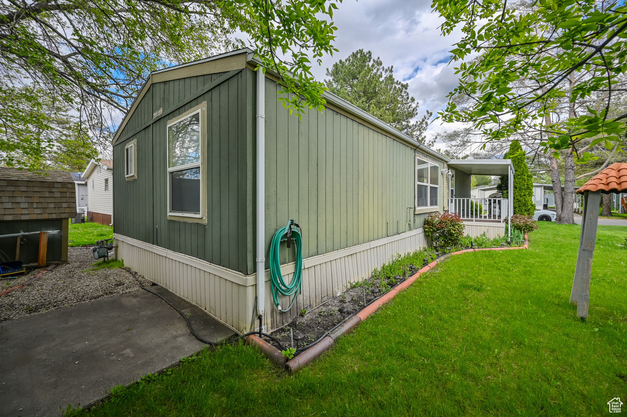 View of property exterior featuring a lawn