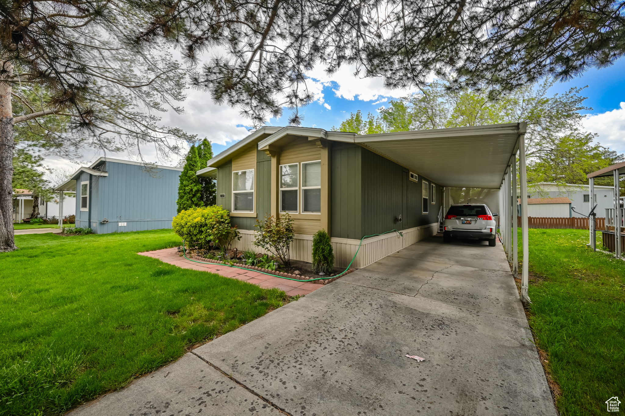 View of front of house with a carport and a front yard