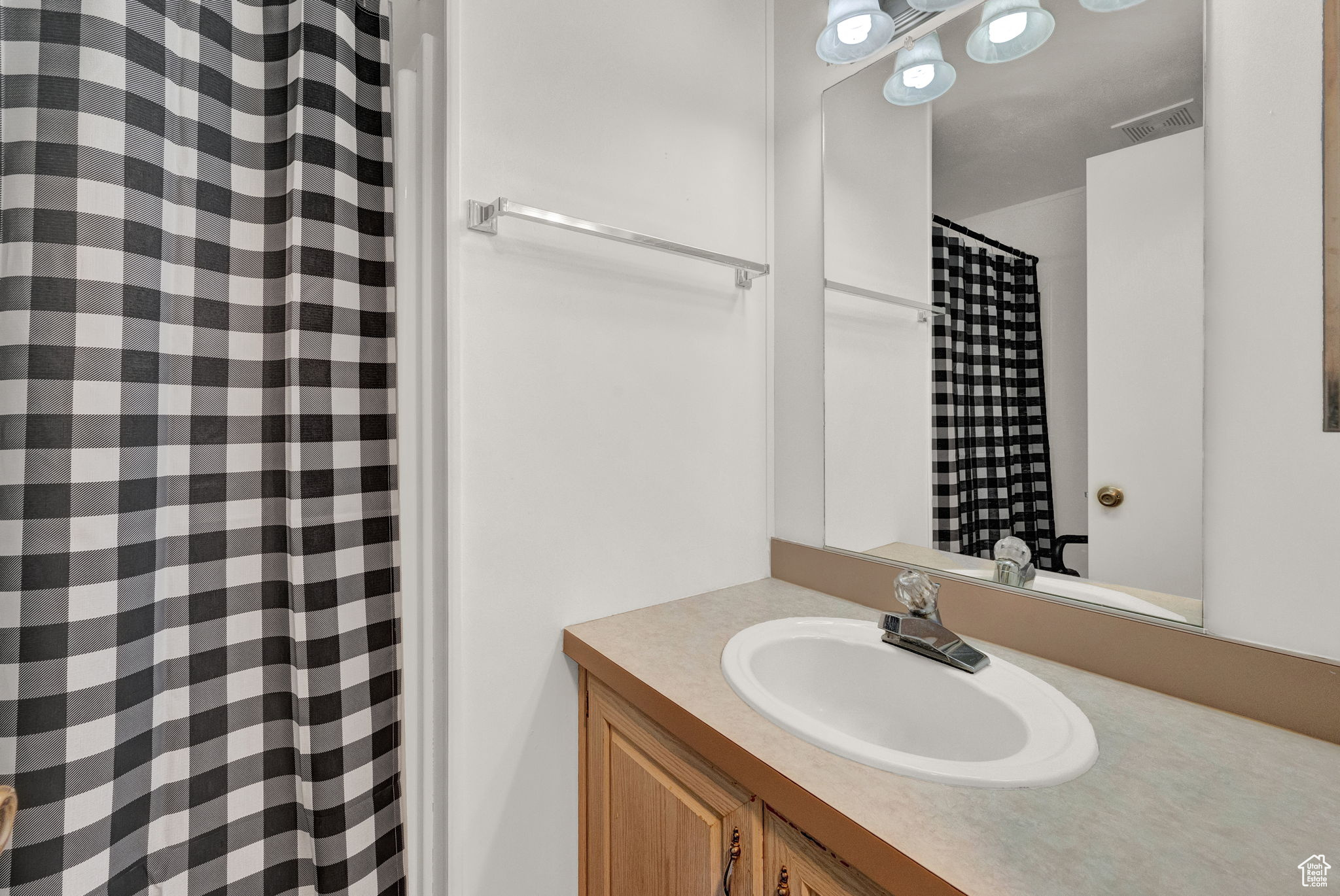 Bathroom featuring vanity with extensive cabinet space