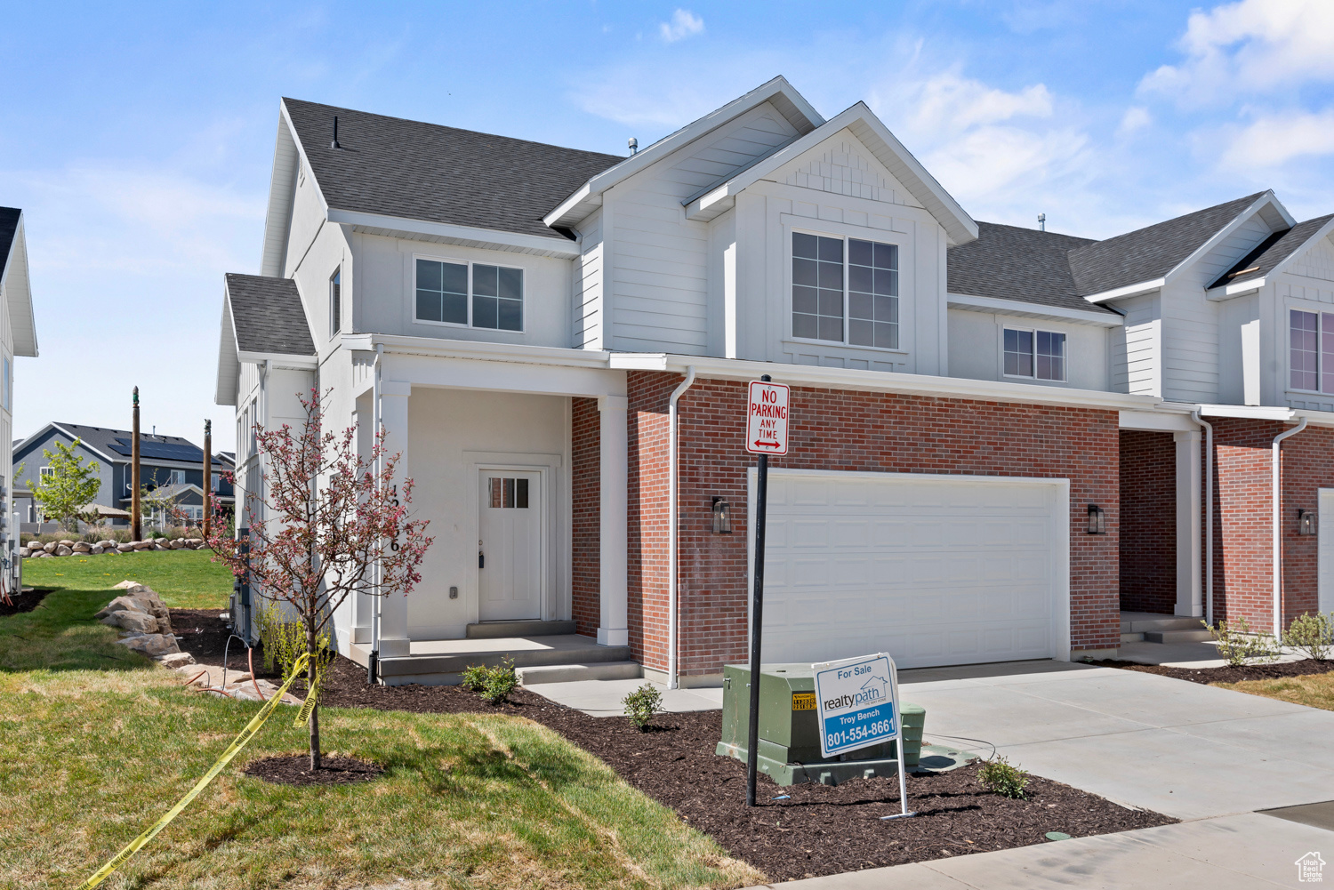 View of front of property featuring a front yard and a garage