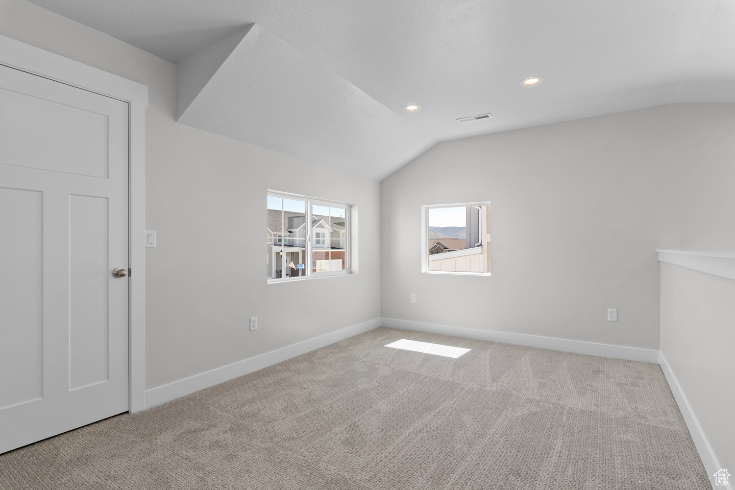 Spare room with lofted ceiling and carpet floors