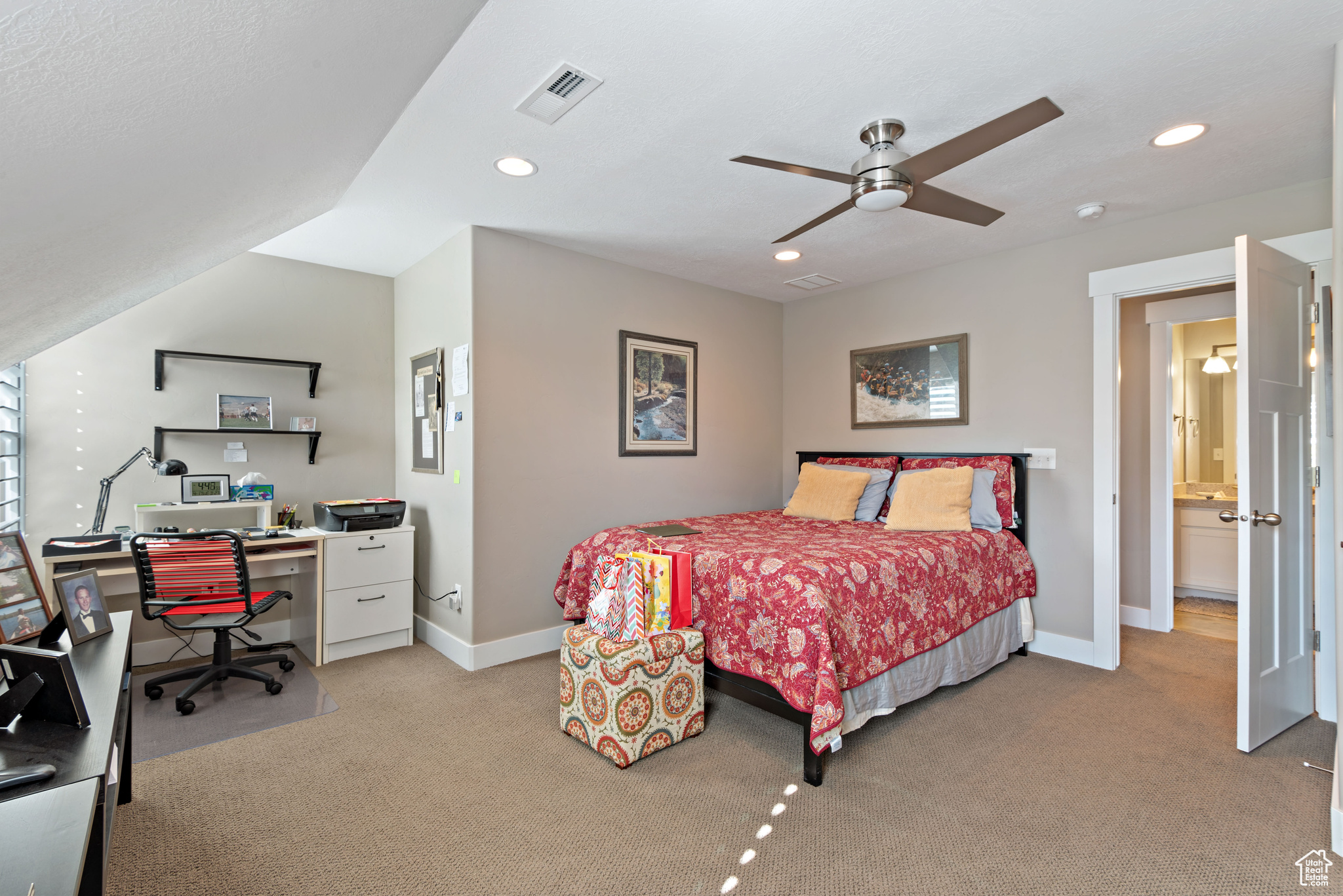 Carpeted bedroom featuring ceiling fan and ensuite bathroom