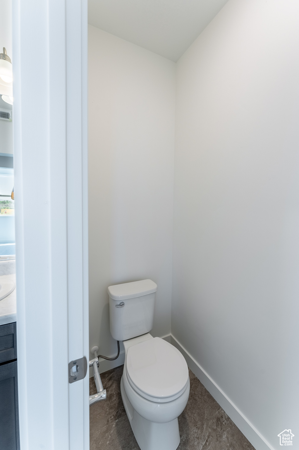 Bathroom featuring vanity, tile floors, and toilet