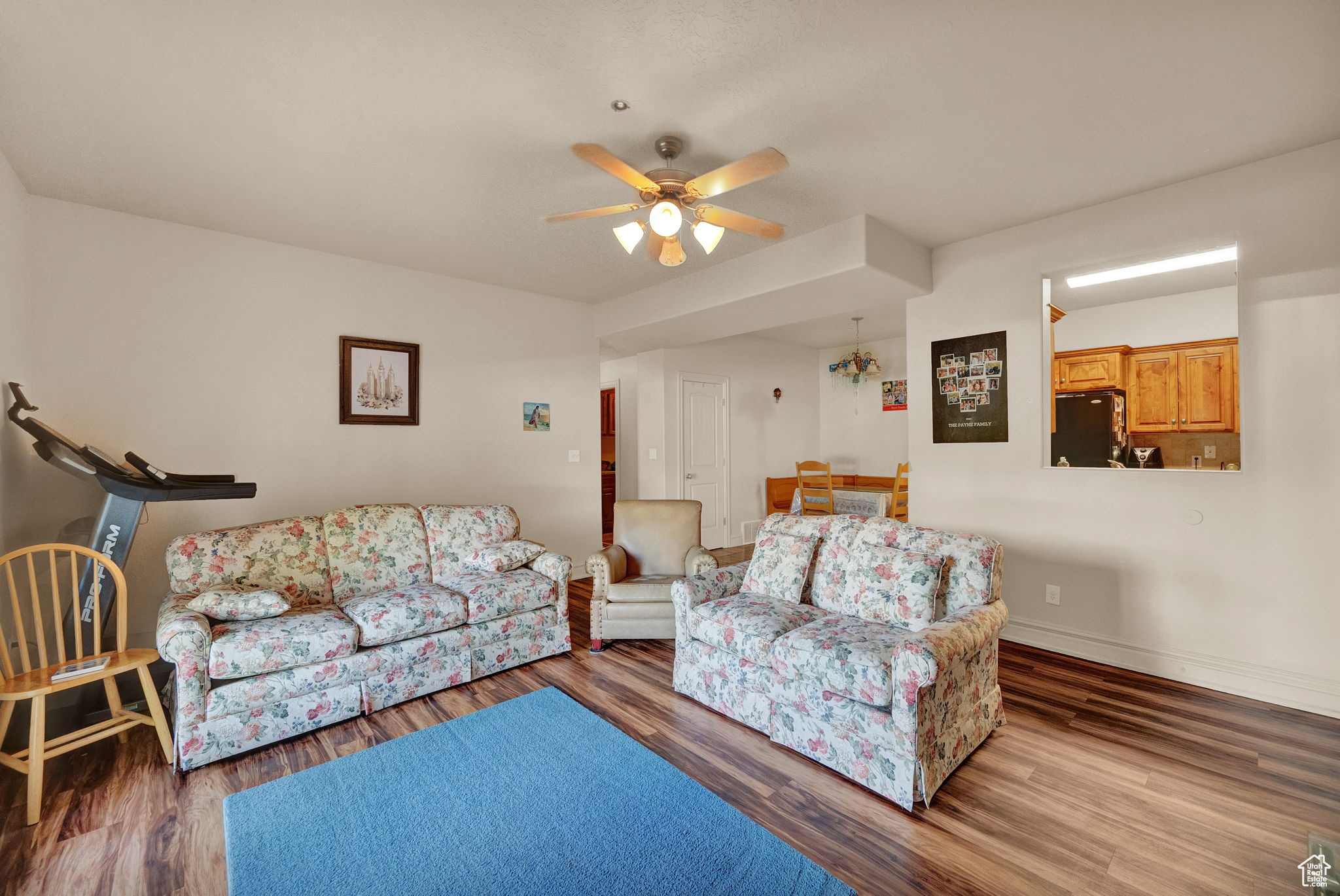 Living room featuring hardwood / wood-style flooring and ceiling fan
