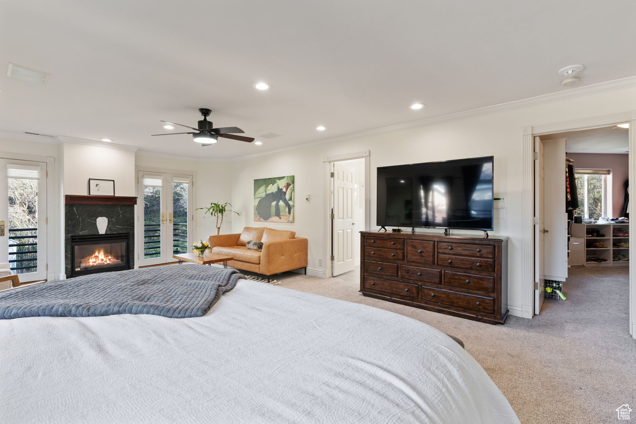 Bedroom featuring ornamental molding, light carpet, ceiling fan, and access to exterior