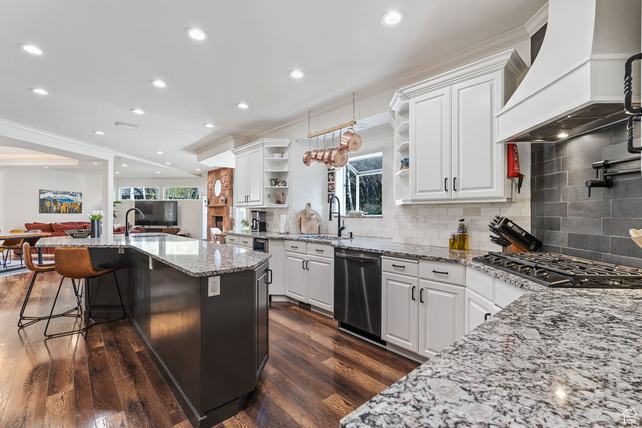 Kitchen with backsplash, dark hardwood / wood-style floors, premium range hood, and white cabinetry
