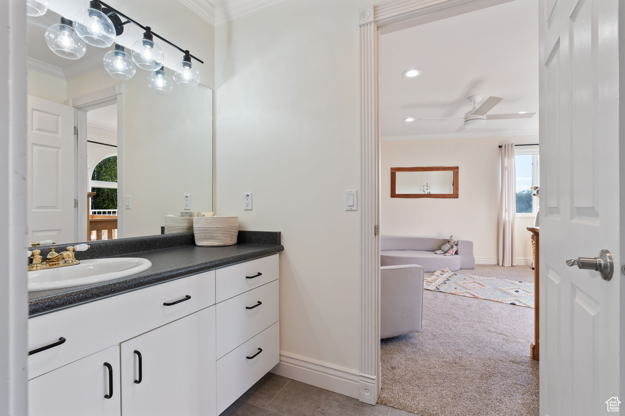 Bathroom with ornamental molding, ceiling fan, vanity, and tile floors