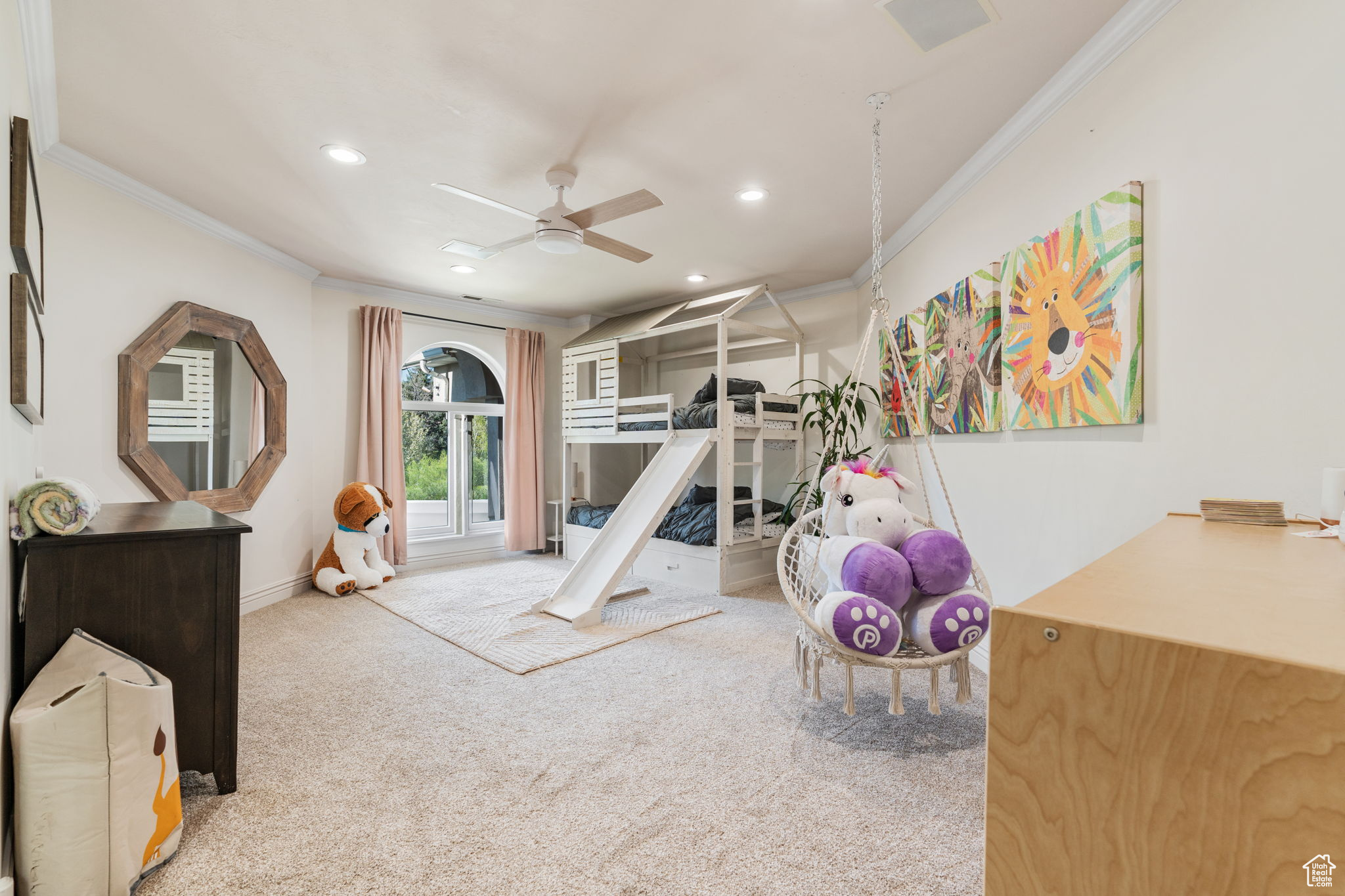 Exercise room with ceiling fan, carpet, and ornamental molding