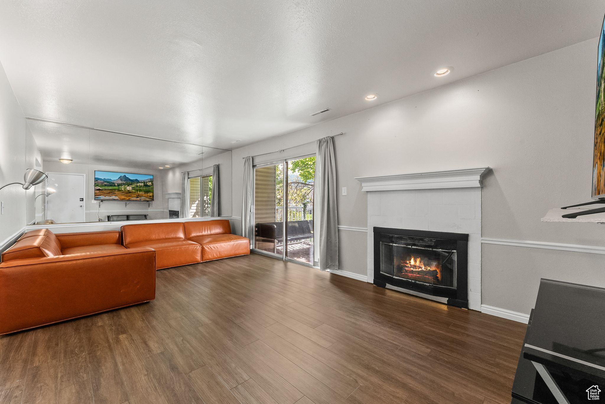 Living room featuring dark hardwood / wood-style flooring and a tiled fireplace