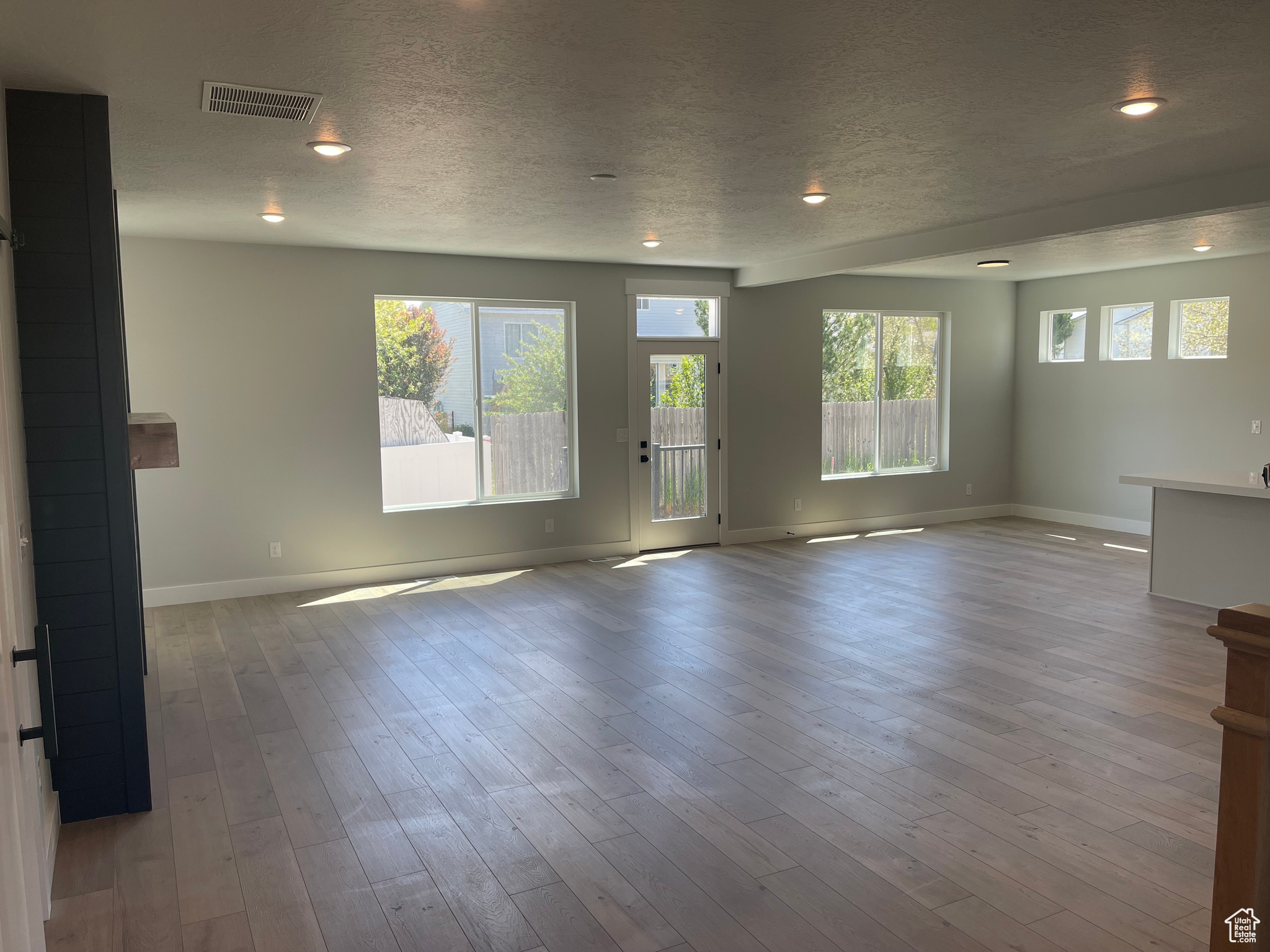 Empty room featuring wood-type flooring and a textured ceiling