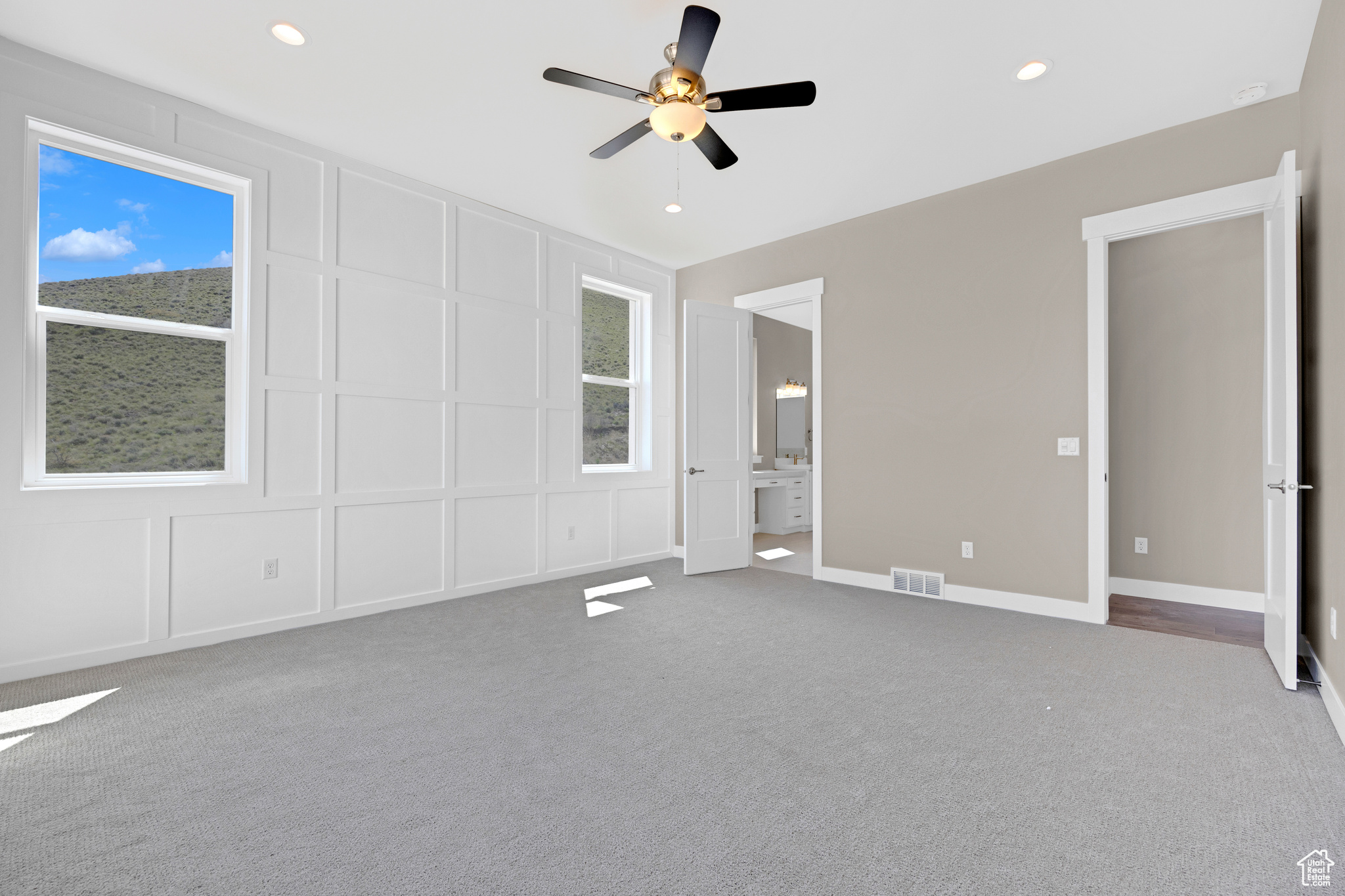 Spare room featuring carpet flooring and ceiling fan