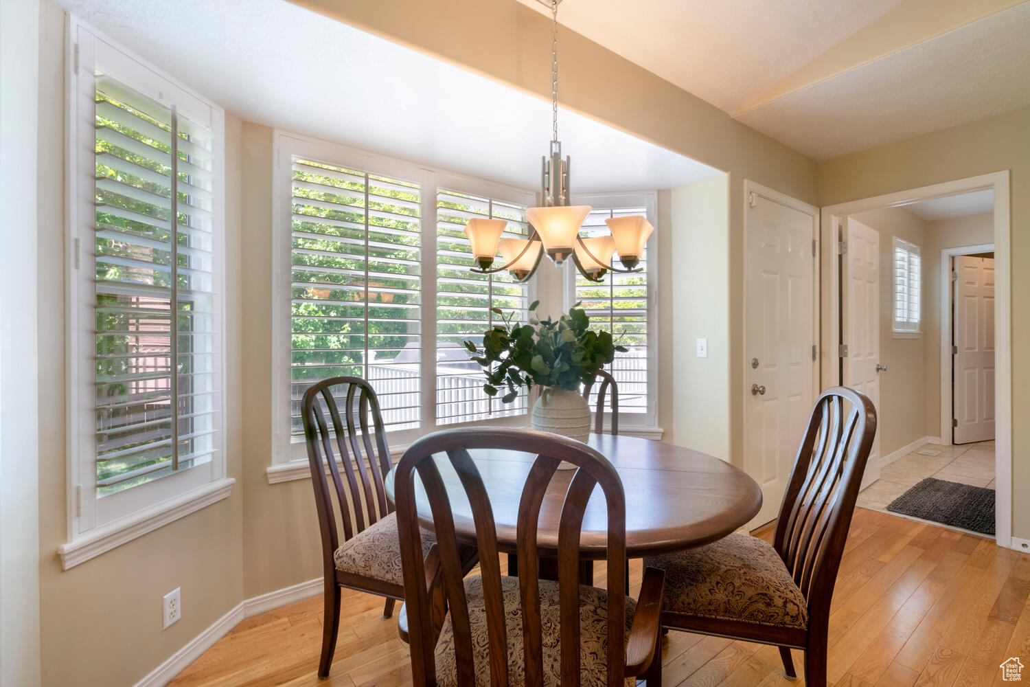 Dining space featuring lots of sunlight, Plantation Shutters and hardwood flooring