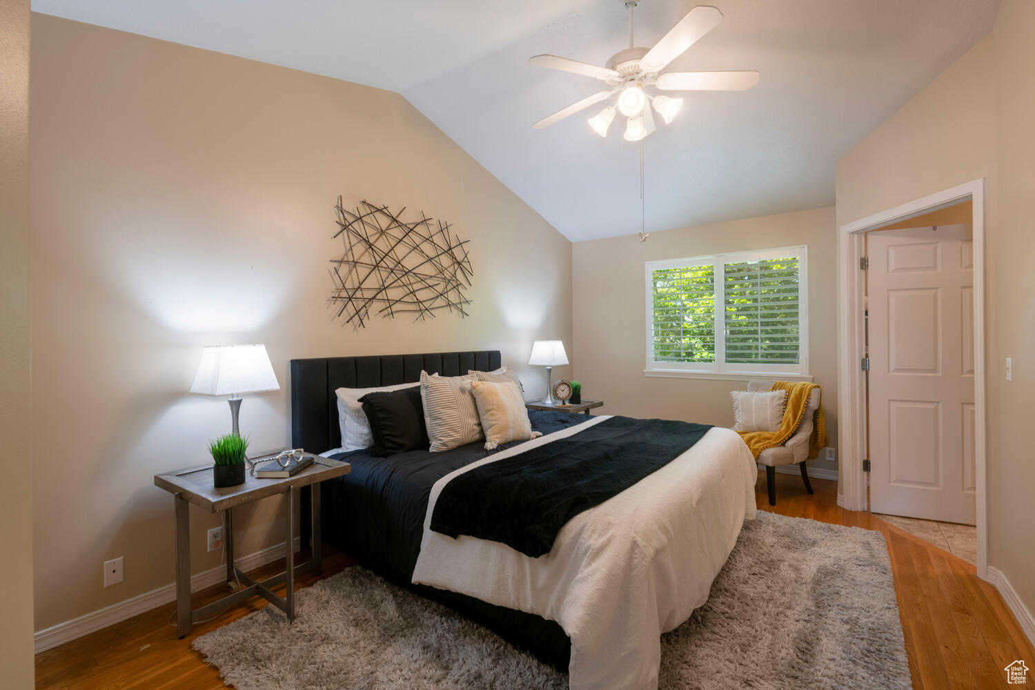 Master Bedroom with hardwood flooring, ceiling fan, and vaulted ceiling