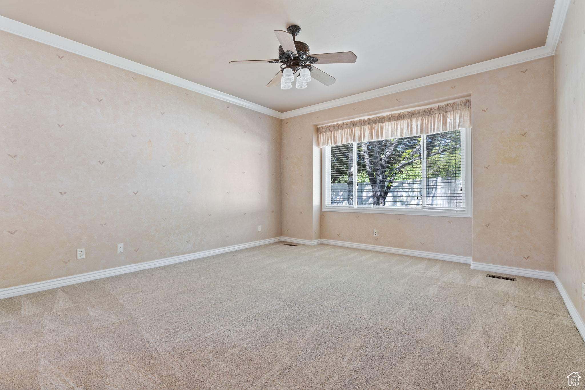 Master bedroom room featuring light carpet, ceiling fan, and crown molding