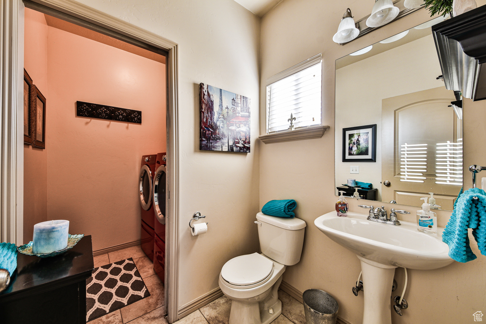 Bathroom with toilet, tile floors, and washing machine and clothes dryer