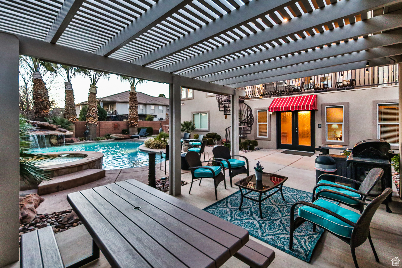 View of patio / terrace with a pool with hot tub, a pergola, and pool water feature