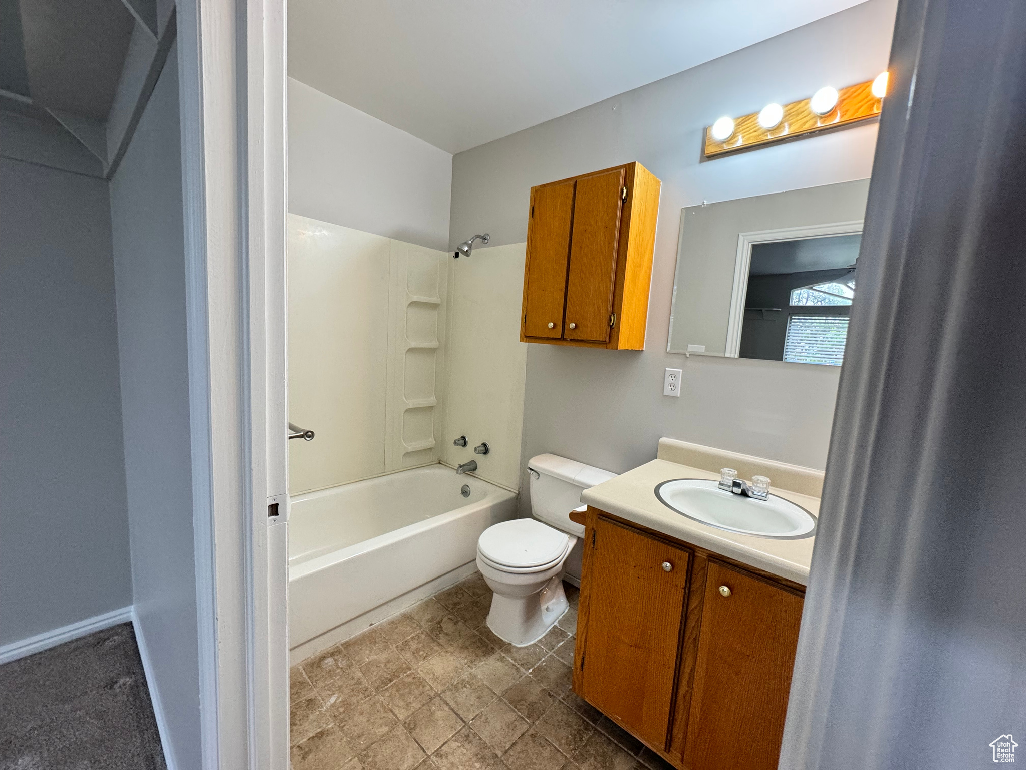 Full bathroom featuring tile floors, toilet, shower / bathing tub combination, and vanity