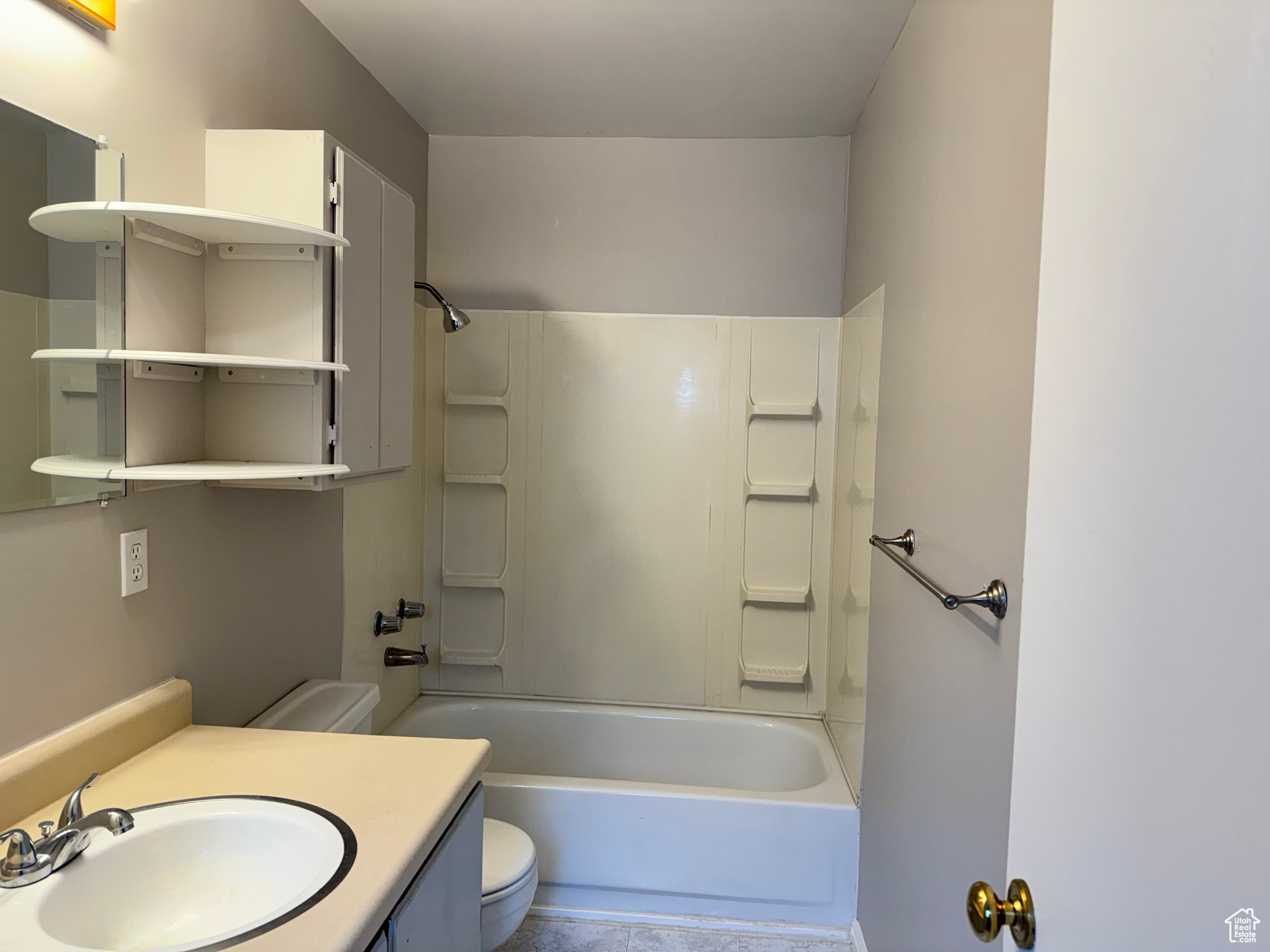 Full bathroom with washtub / shower combination, oversized vanity, tile floors, and toilet
