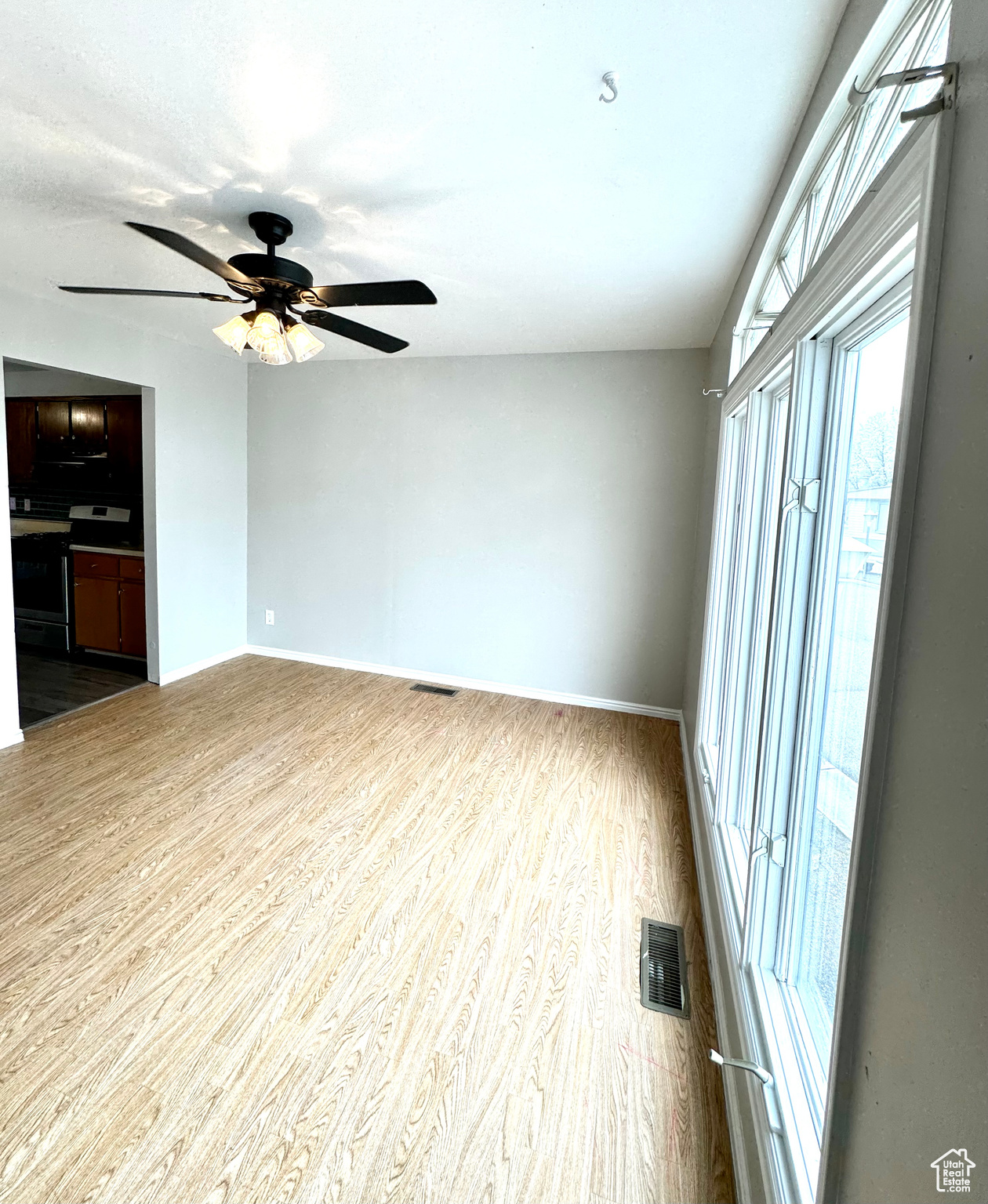 Primary suite featuring light hardwood / wood-style floors and ceiling fan.