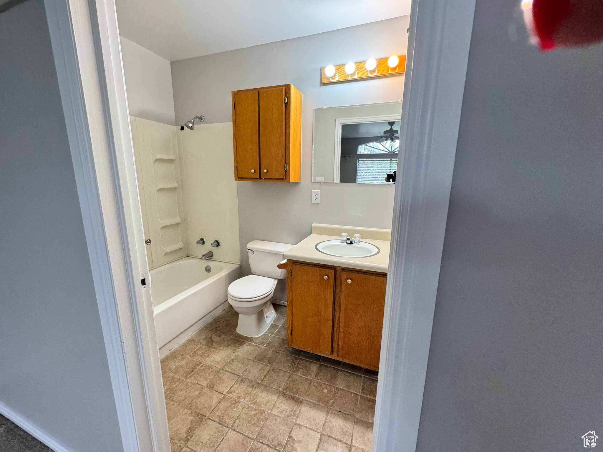Full bathroom featuring tile flooring, shower / bathtub combination, vanity, and toilet