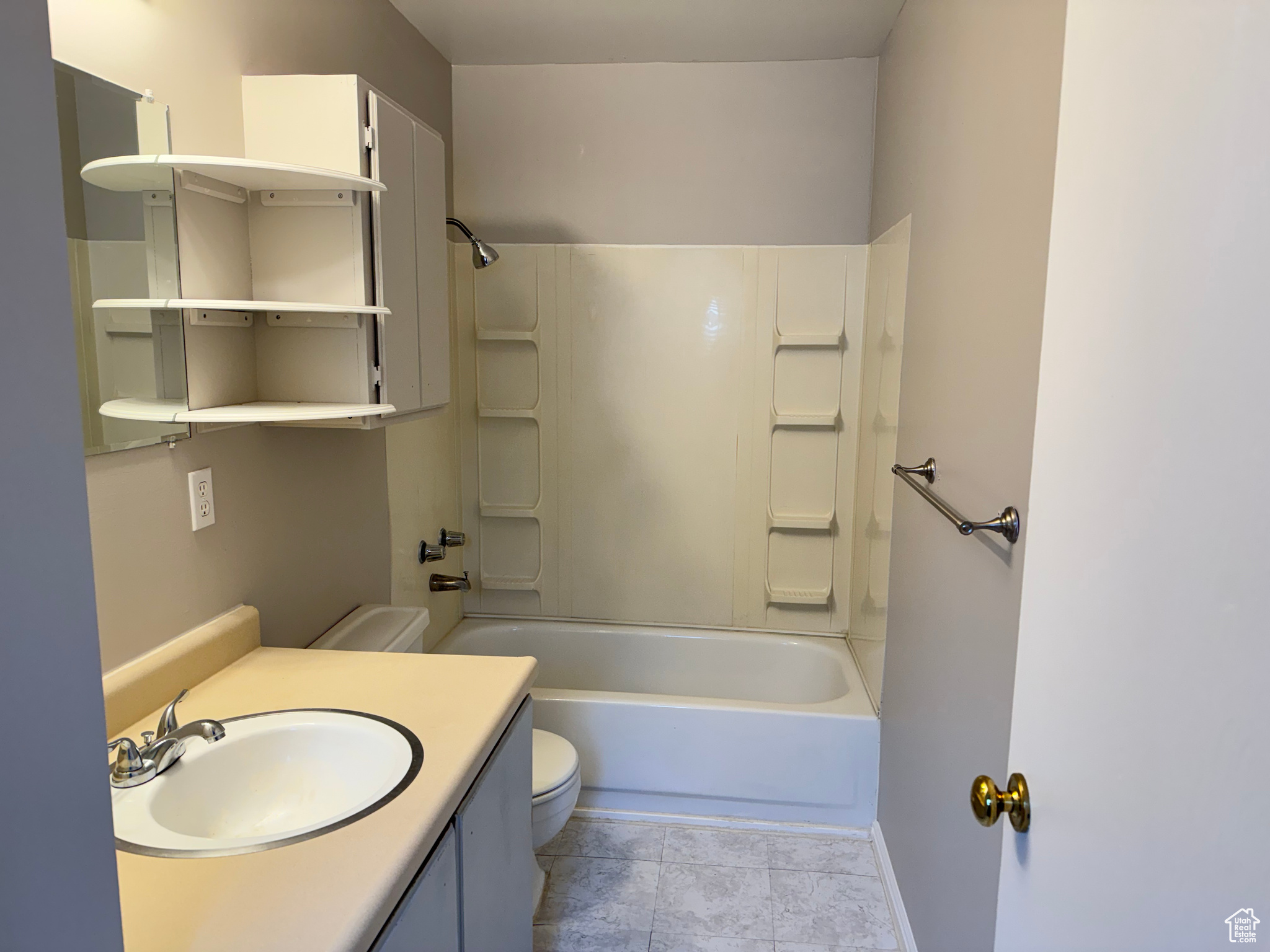 Full bathroom with tile floors, toilet, tub / shower combination, and large vanity