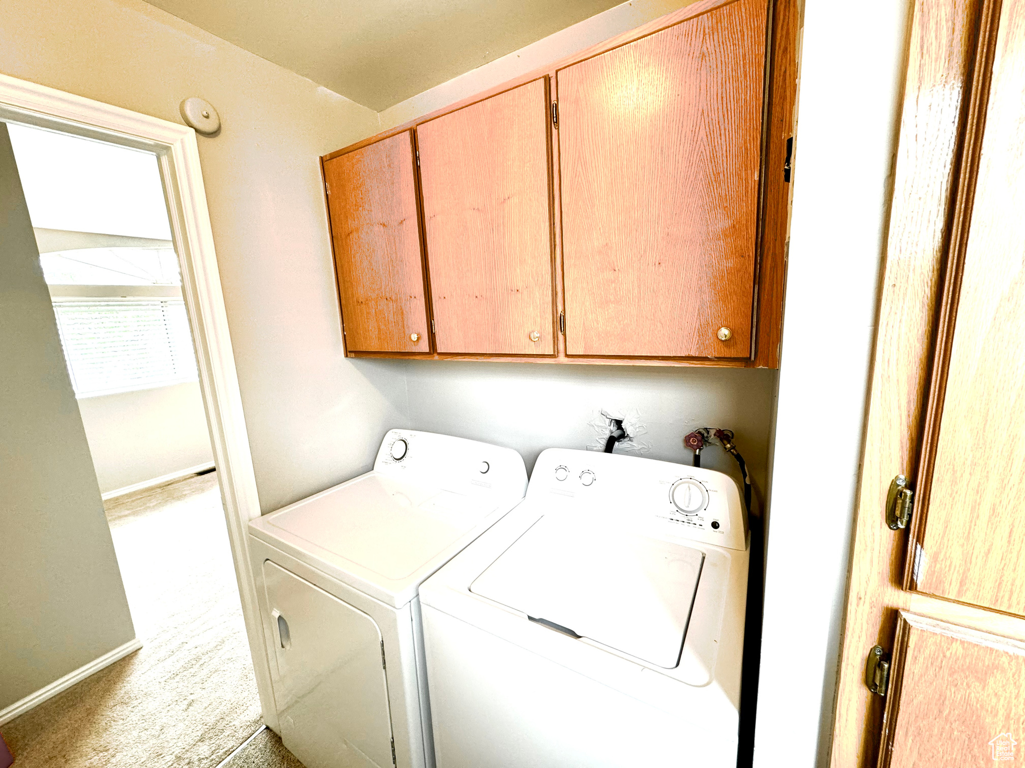 Clothes washing area with cabinets, independent washer and dryer, washer hookup, and carpet flooring