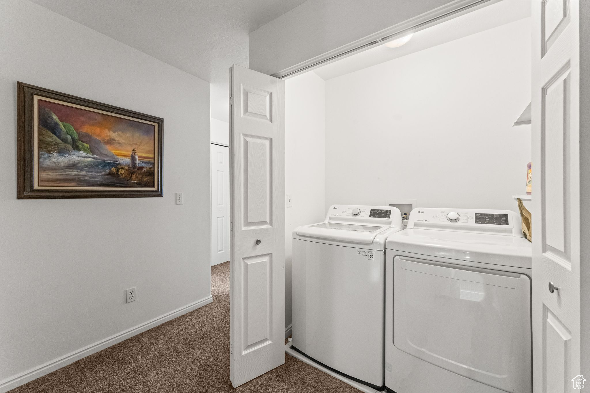 Laundry area with independent washer and dryer and dark carpet