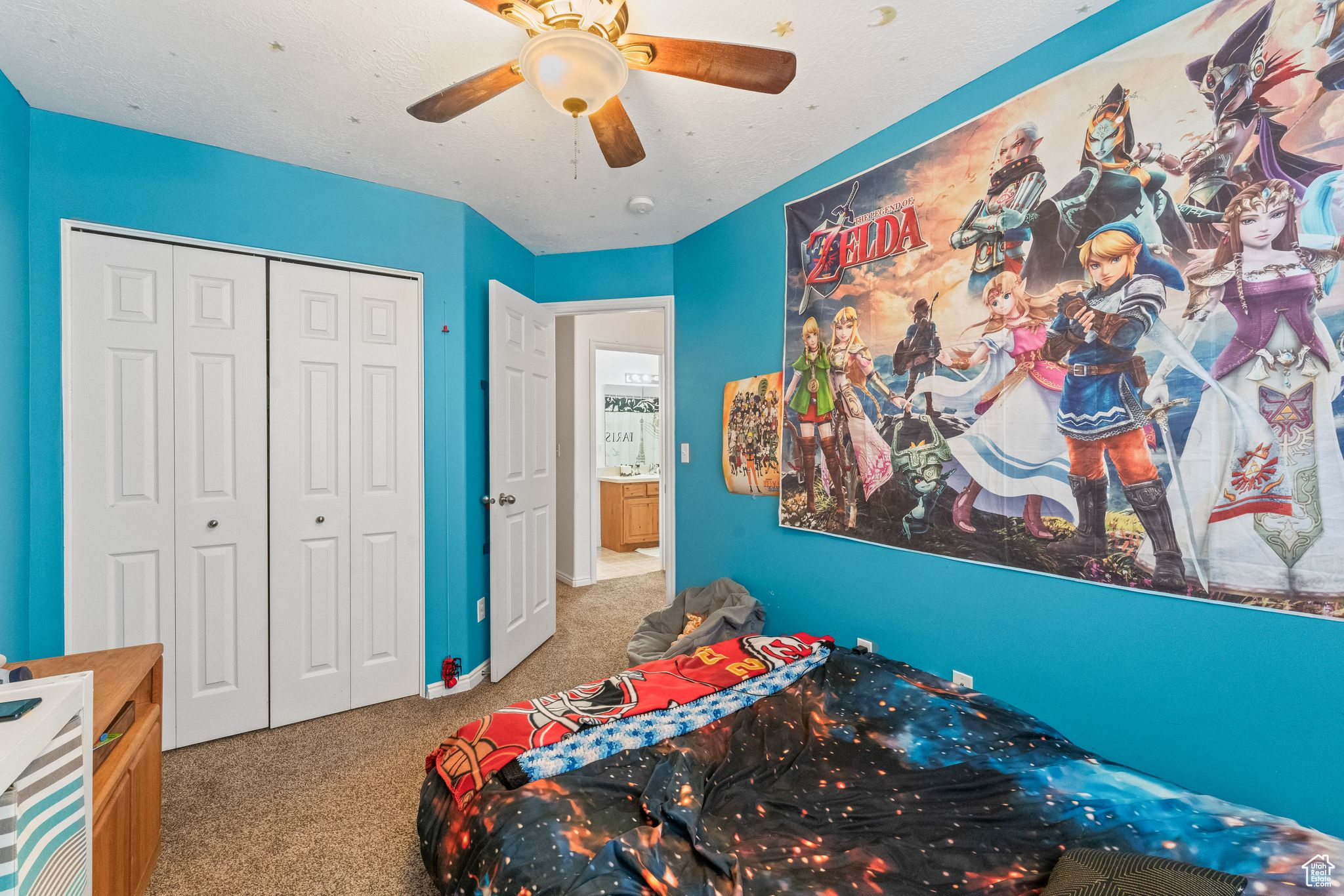 Carpeted bedroom featuring a closet and ceiling fan