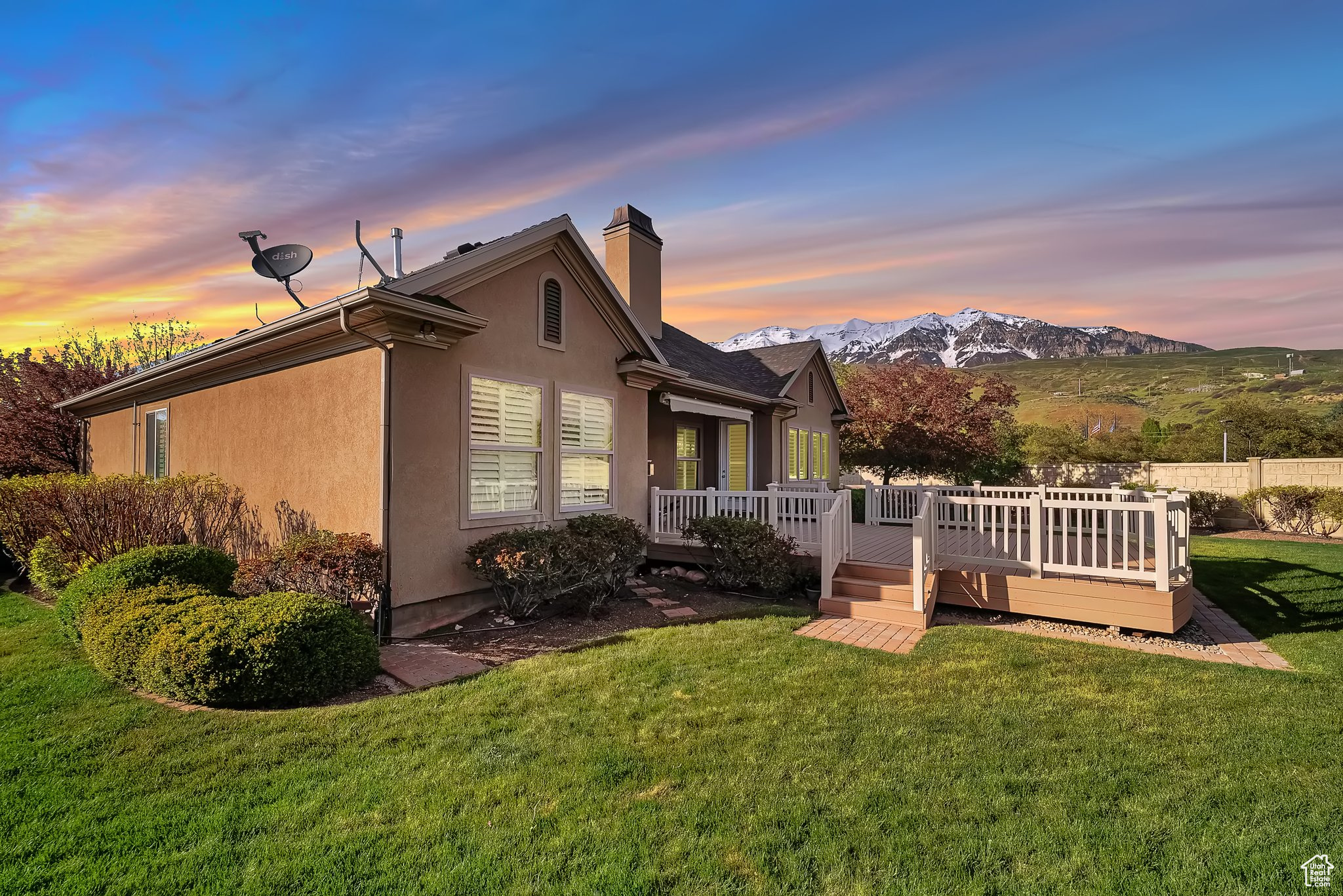 Exterior space featuring a yard and a deck with mountain view