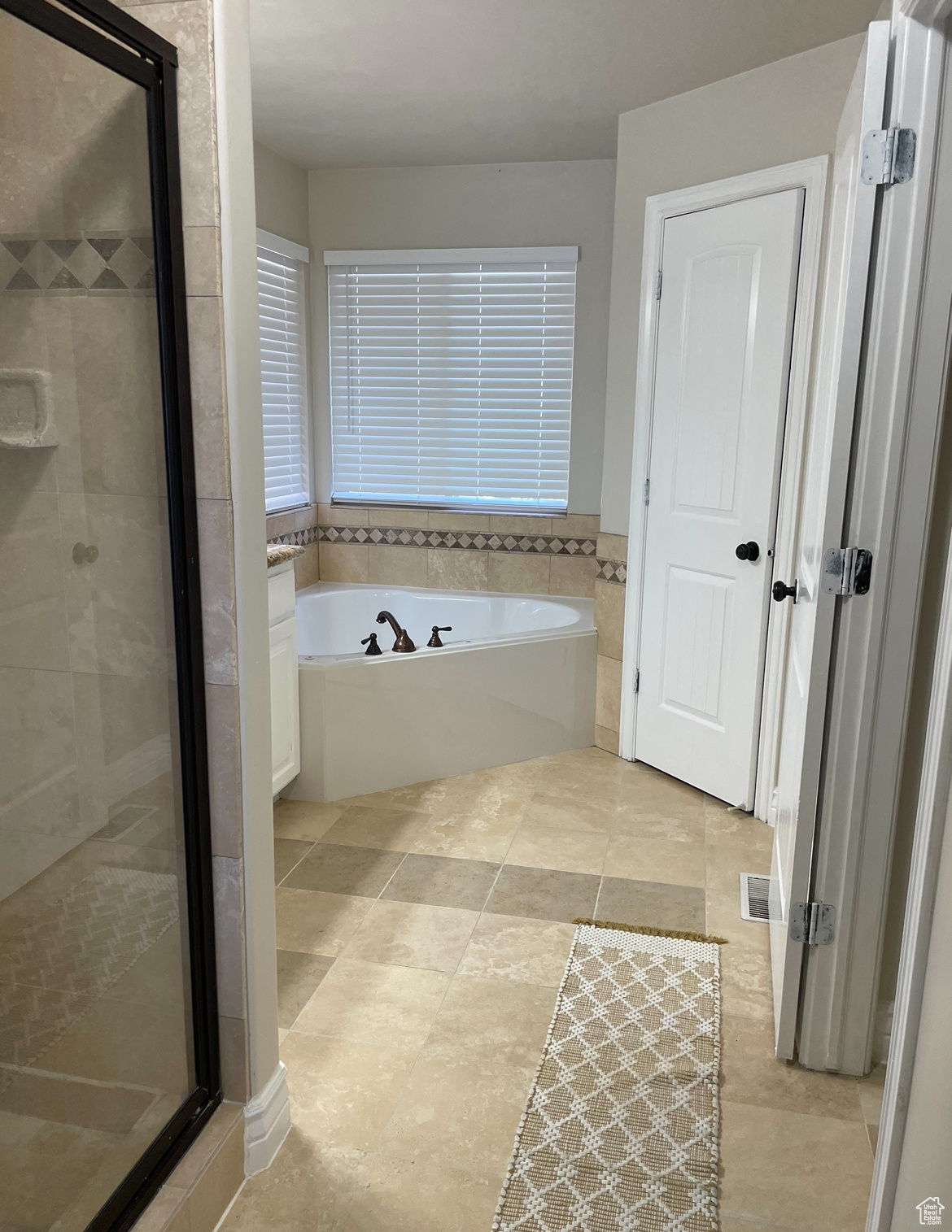 Bathroom featuring independent shower and bath and tile patterned floors