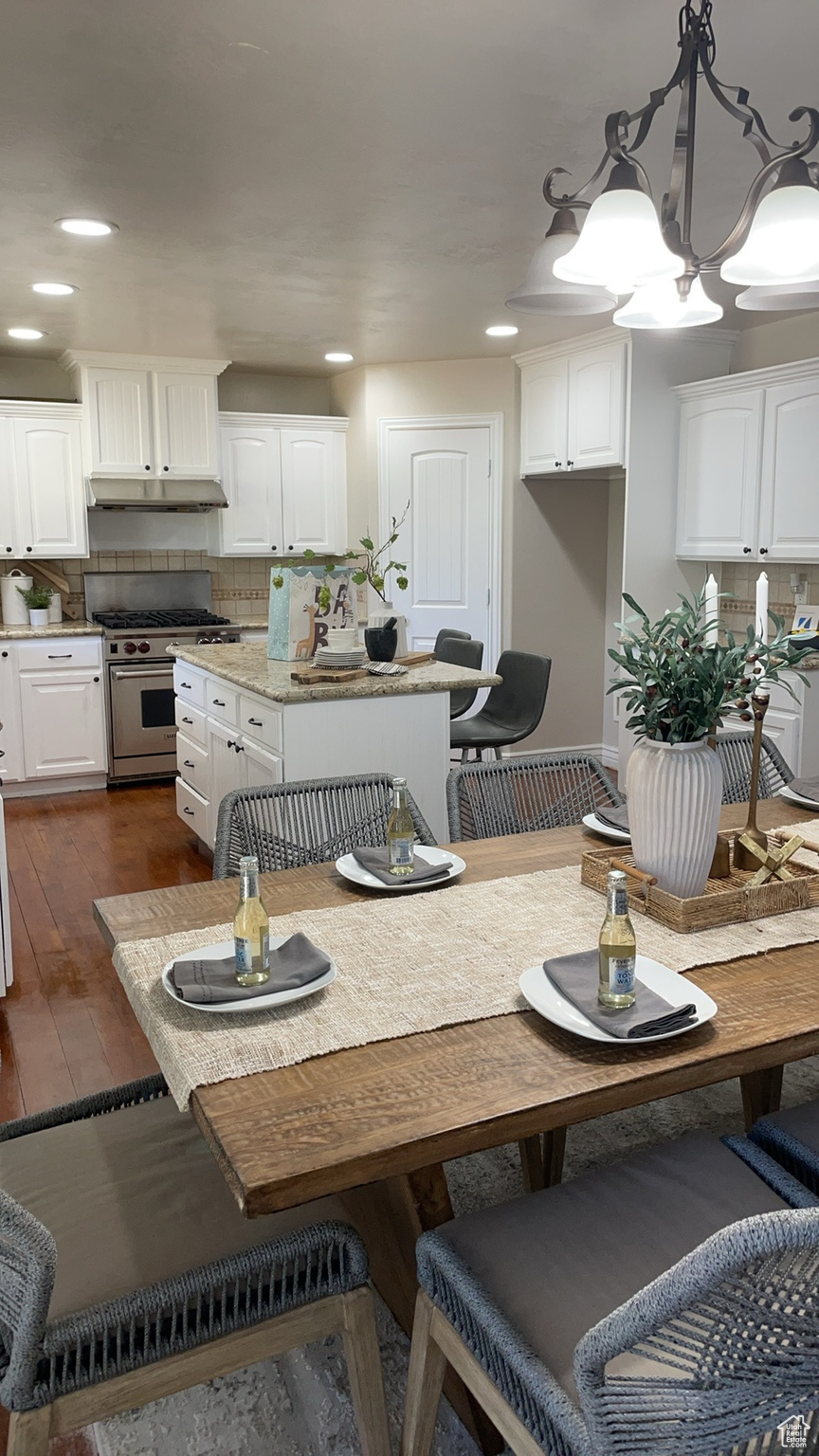 Dining space with dark hardwood / wood-style floors