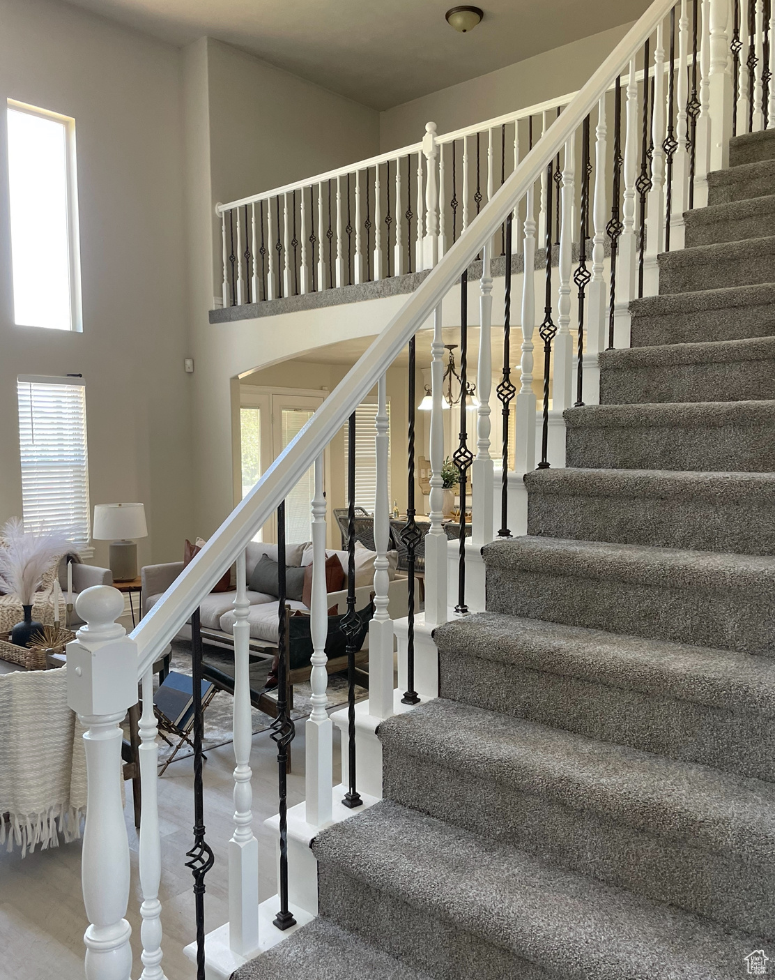 Stairs featuring a high ceiling