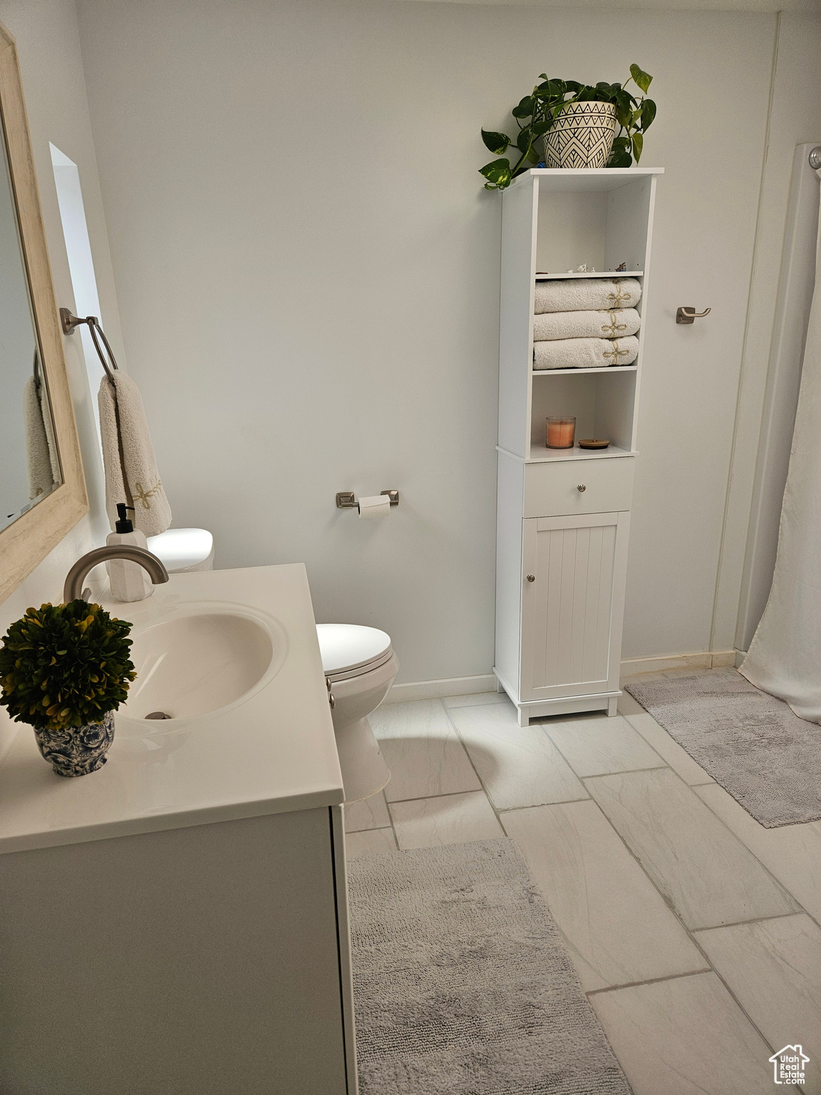 Bathroom with vanity, toilet, and tile flooring