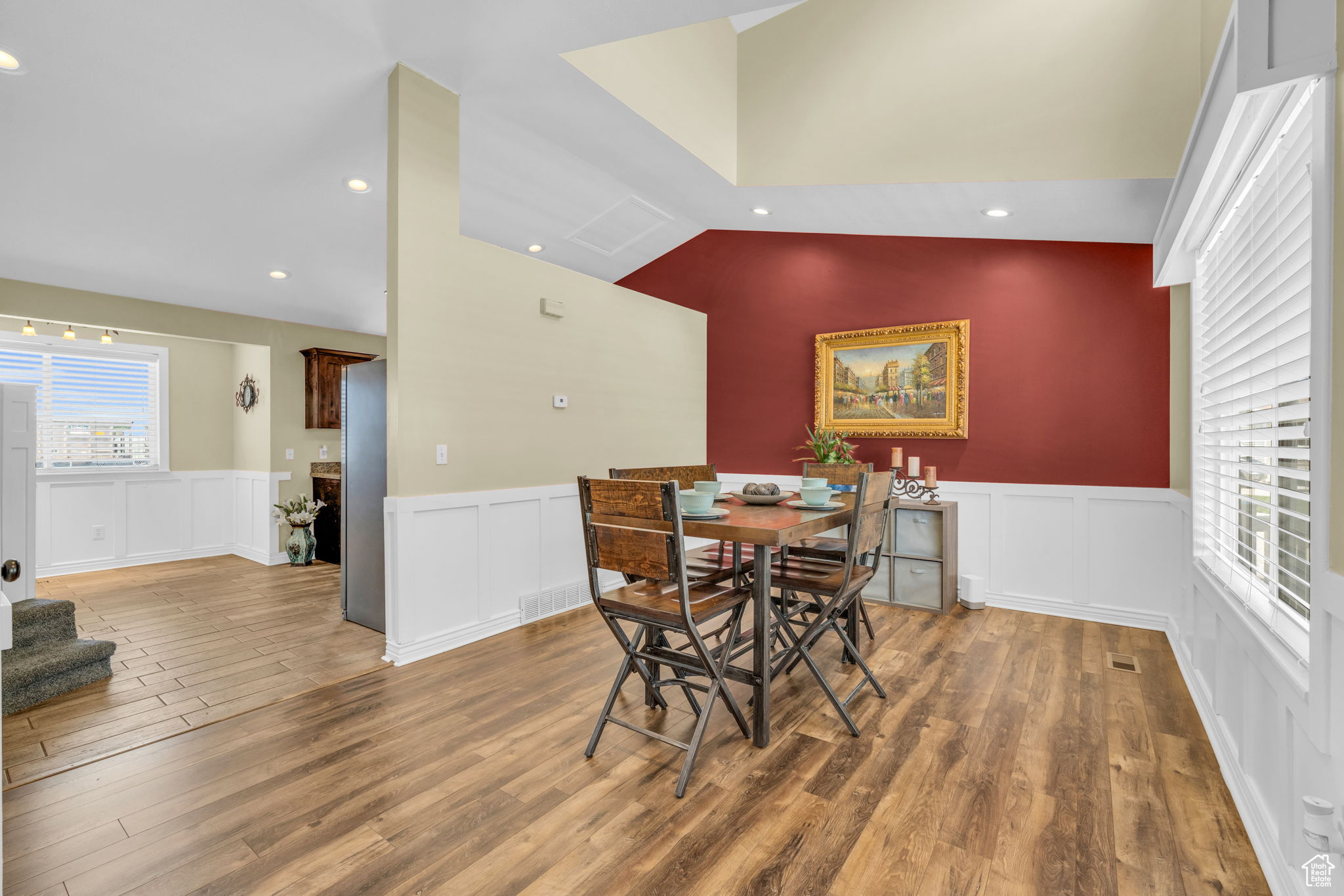 Dining space featuring vaulted ceiling and hardwood / wood-style flooring
