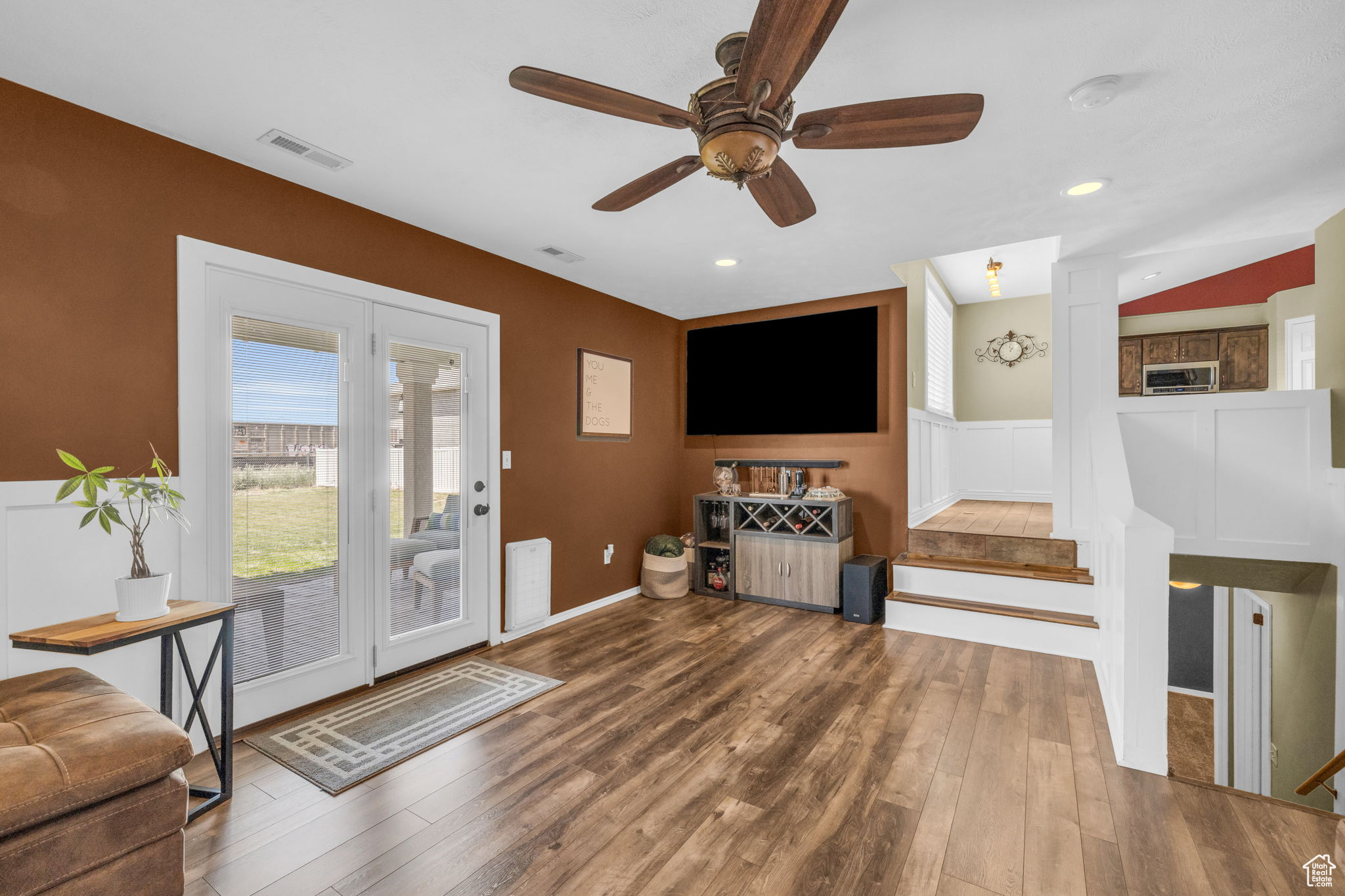 Entrance foyer with dark wood-type flooring and ceiling fan