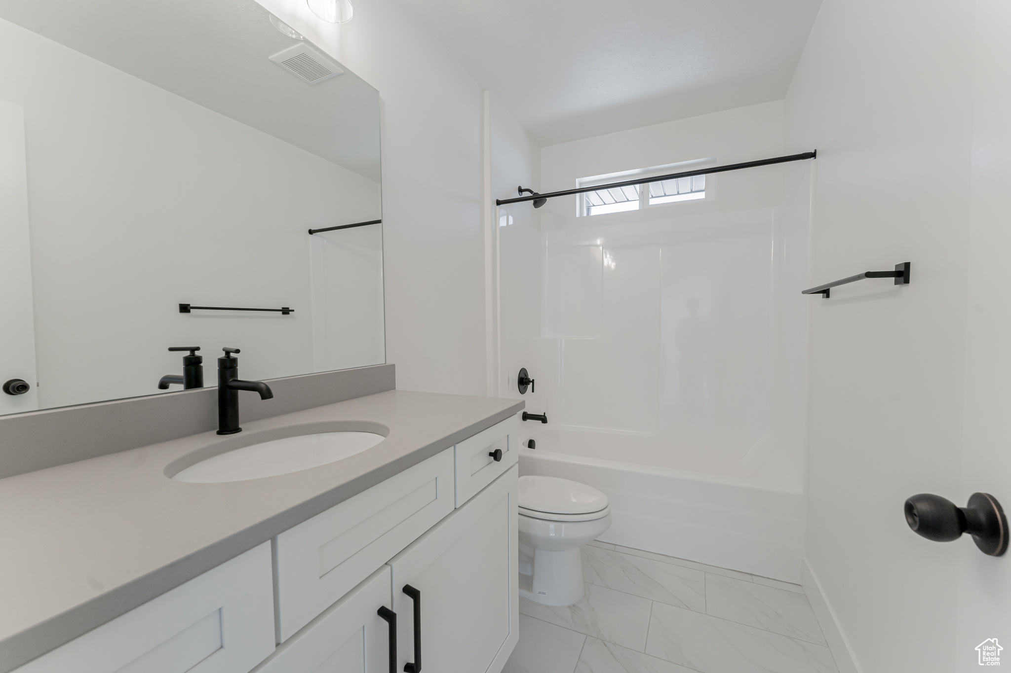 Full bathroom featuring vanity, toilet, and  shower combination