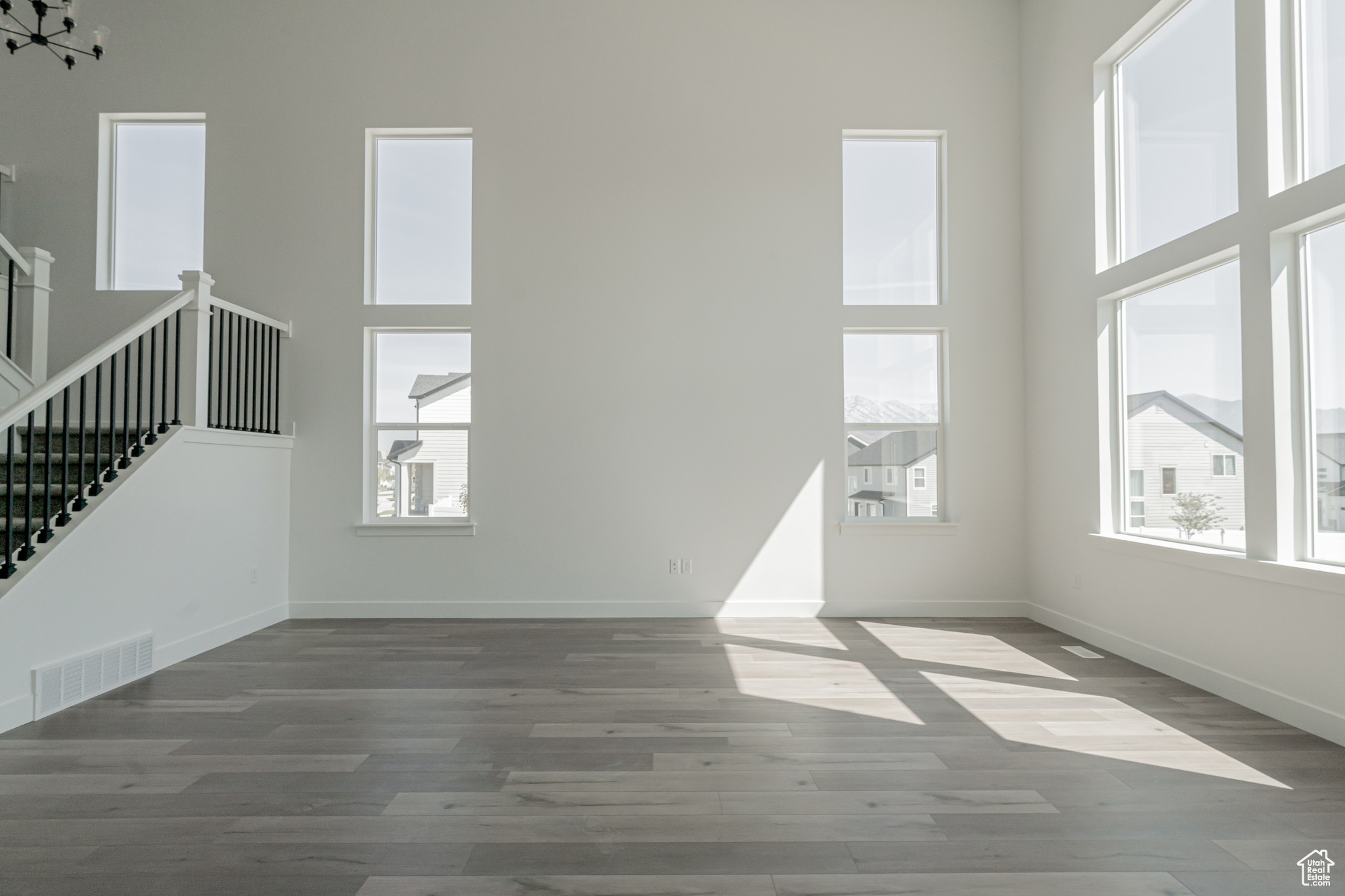 Interior space with a healthy amount of sunlight, a high ceiling, and light hardwood / wood-style floors