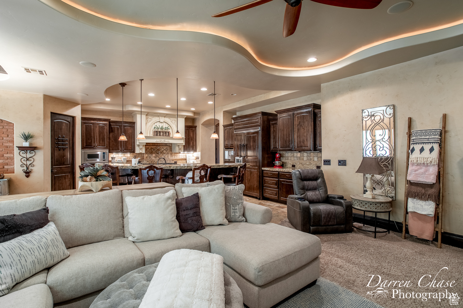 Living room featuring light colored carpet and ceiling fan