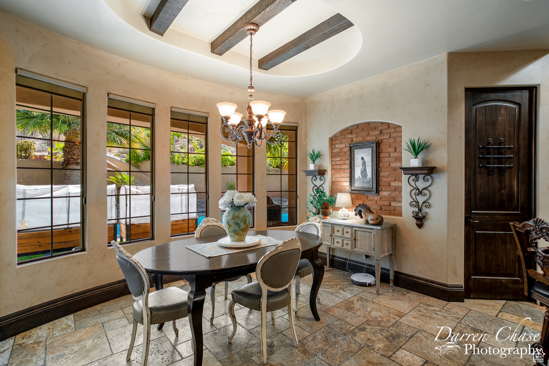 Tiled dining space with beam ceiling and a notable chandelier