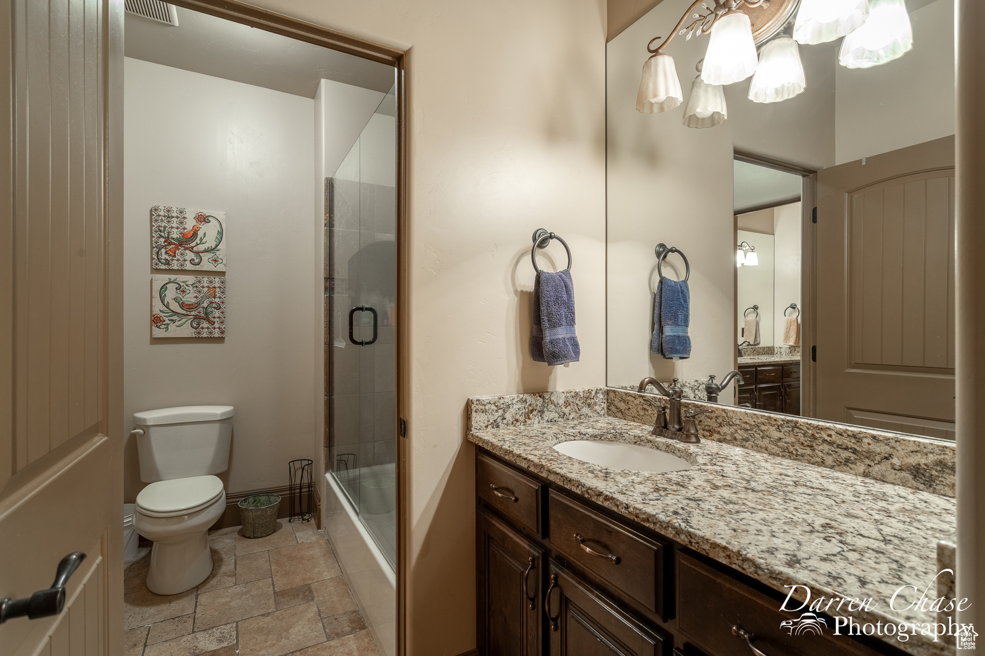 Jack & Jill bathroom between bedrooms 4&5 upstairs.  vanity with extensive cabinet space, tile floors, toilet, and enclosed tub / shower combo