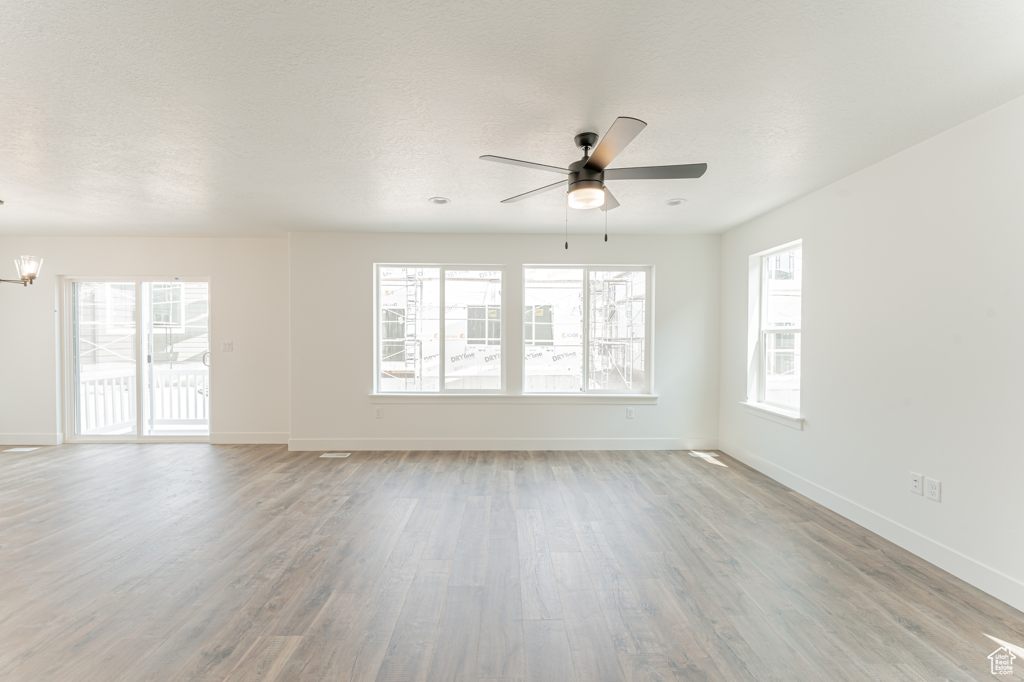 Spare room with hardwood / wood-style flooring and ceiling fan