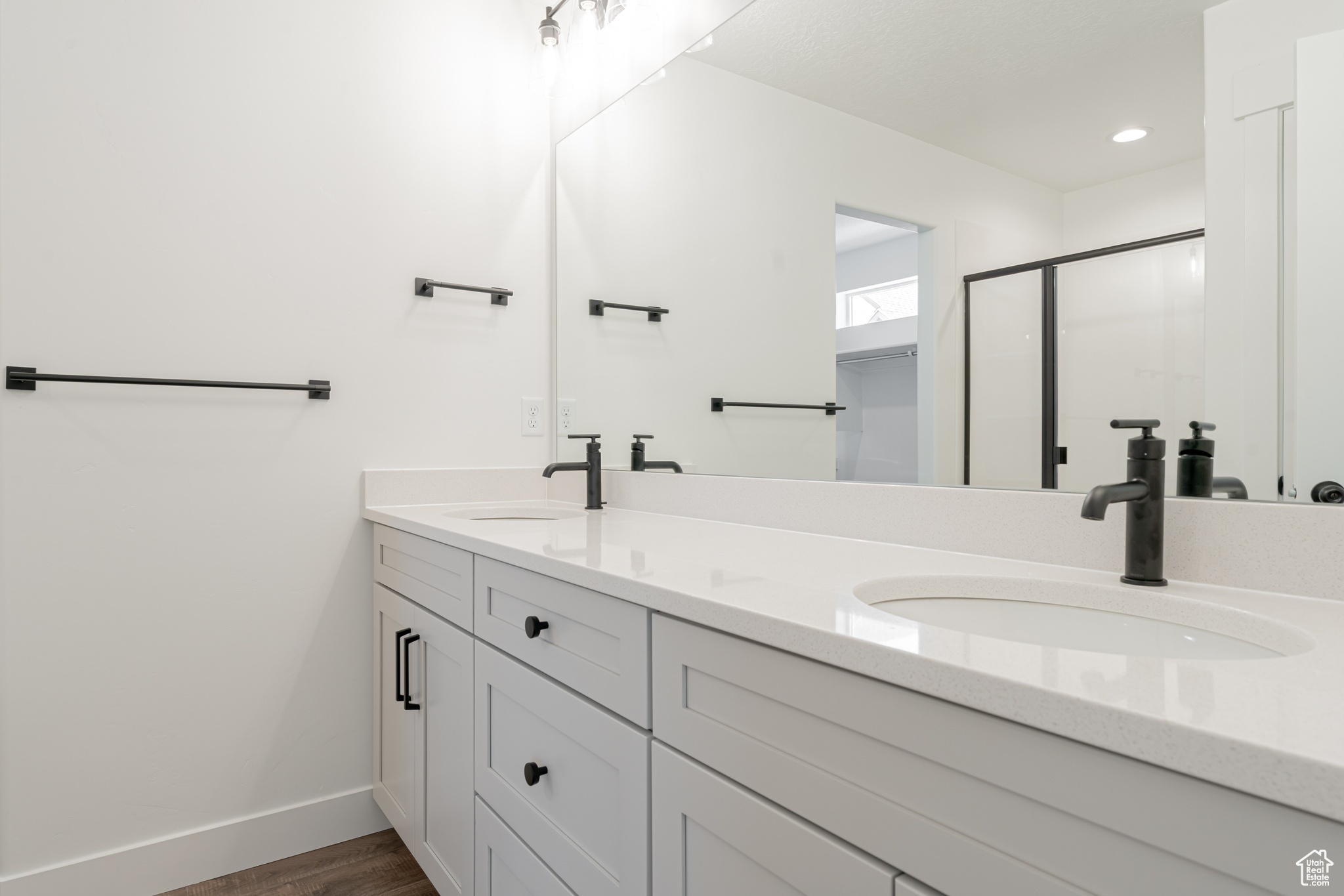 Bathroom with hardwood / wood-style floors and double vanity