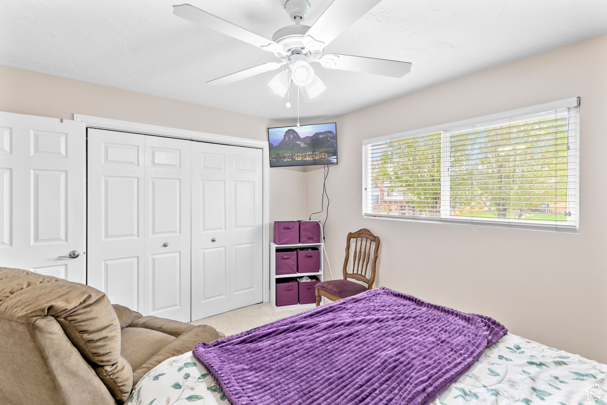 Bedroom featuring a closet, ceiling fan, and carpet