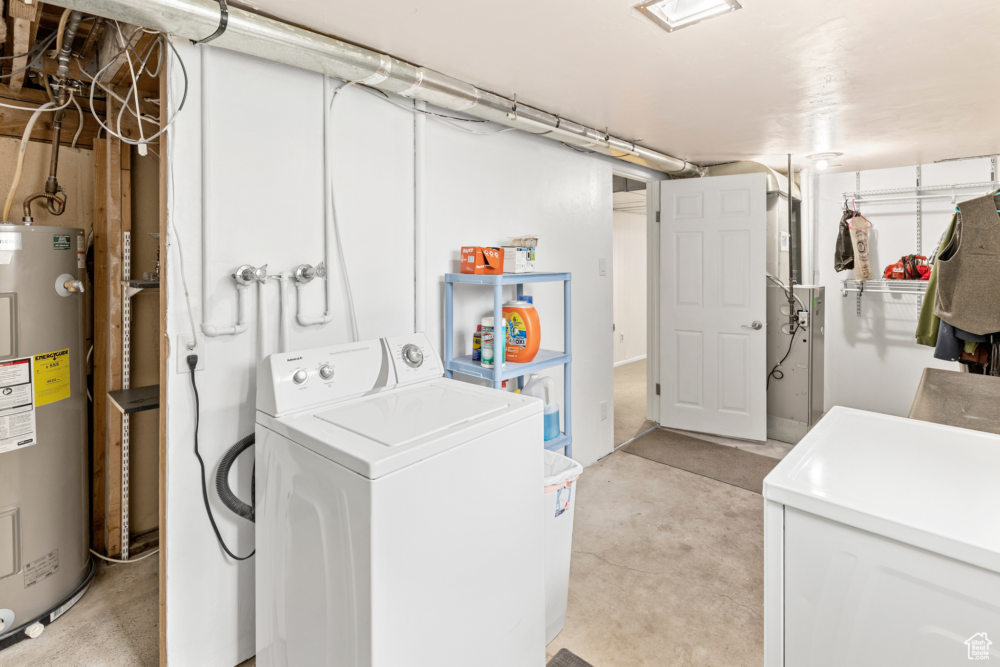 Laundry room featuring separate washer and dryer and electric water heater