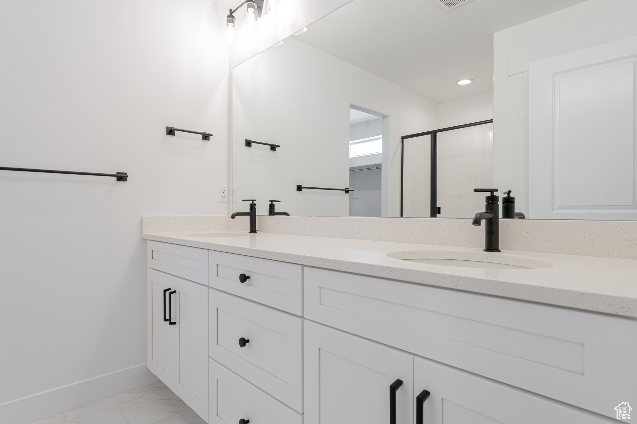 Bathroom with dual vanity and tile patterned floors