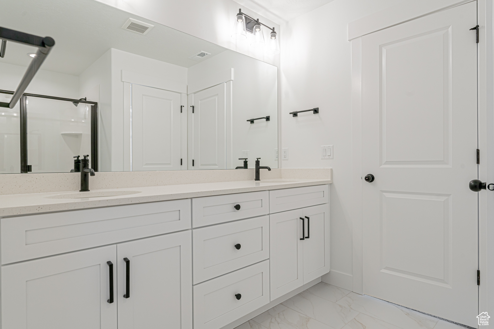 Bathroom with tile patterned floors and dual bowl vanity