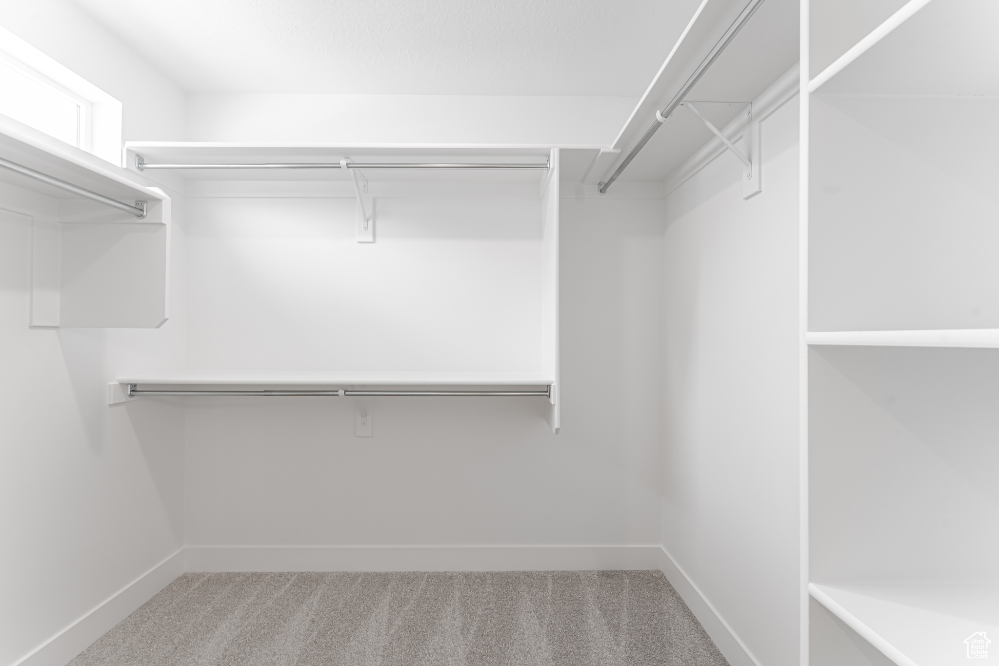 Spacious closet with carpet